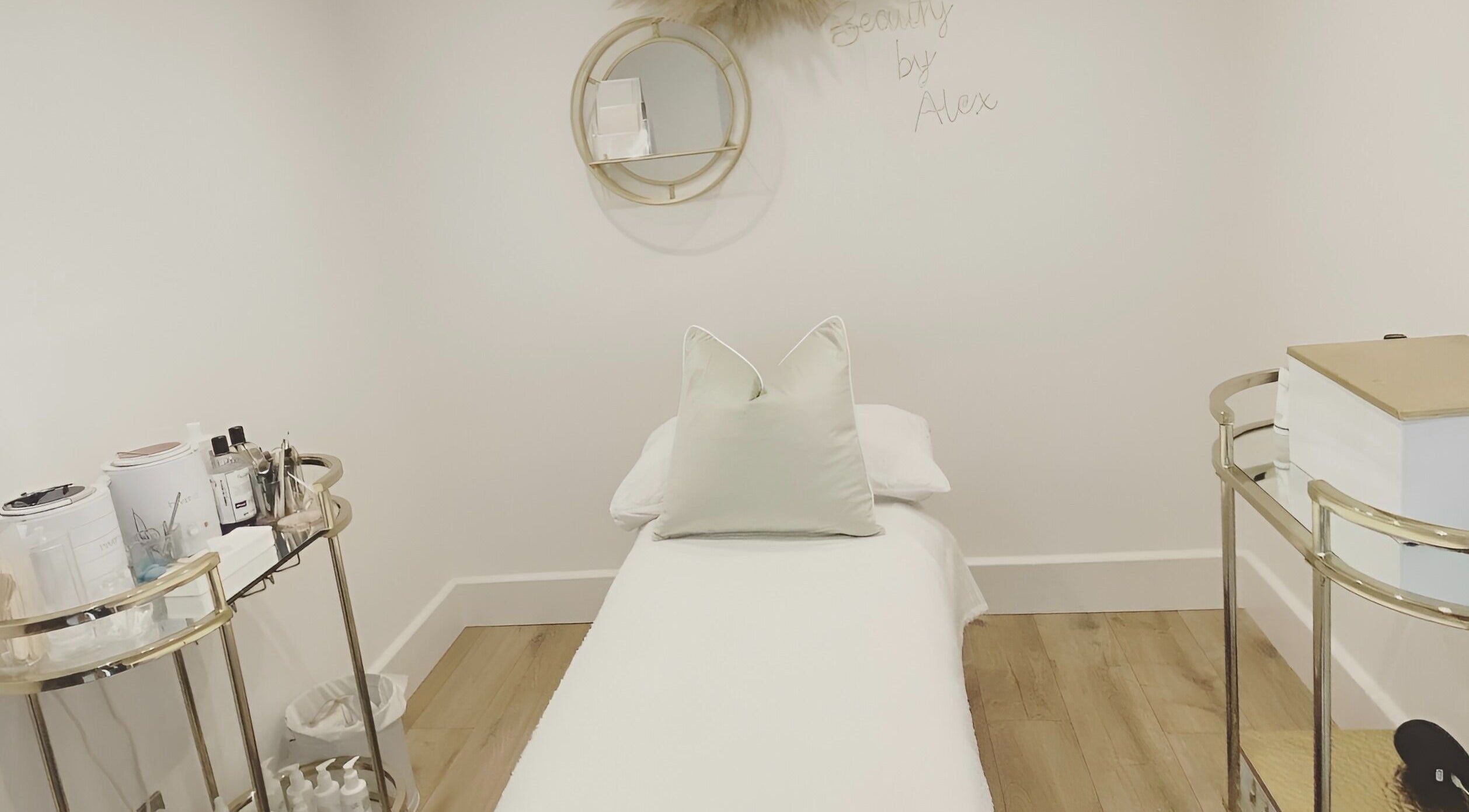 Tranquil treatment room at Beauty by Alex in Rugeley, England, GB, featuring a bed and elegant decor.