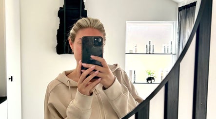 Selfie in mirror at RJ Beauty & Aesthetics, Dalkeith, Scotland, GB, showcasing modern, minimalistic décor.