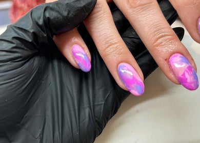 Close-up of vibrant pink and purple nails at RJ Beauty & Aesthetics, Dalkeith, Scotland, GB.