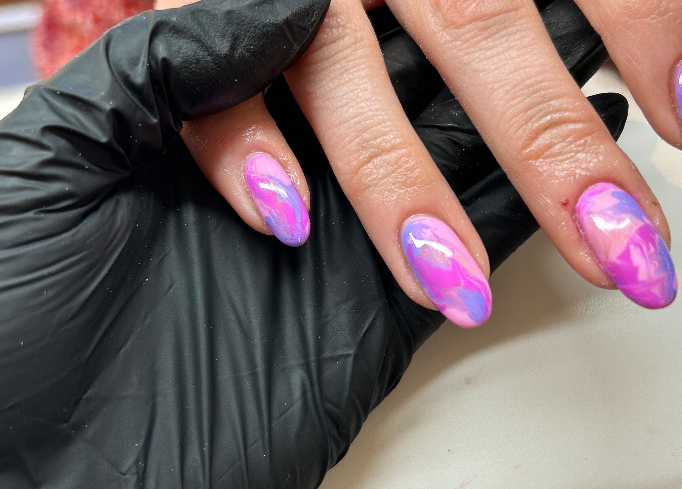 Close-up of vibrant pink and purple nails at RJ Beauty & Aesthetics, Dalkeith, Scotland, GB.