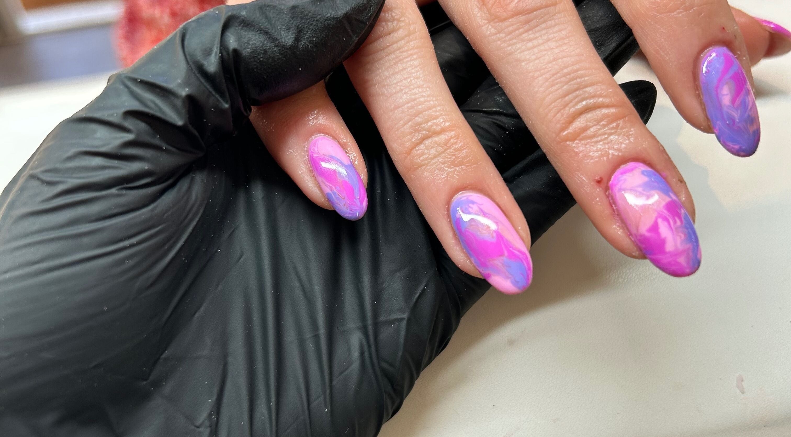 Close-up of vibrant pink and purple nails at RJ Beauty & Aesthetics, Dalkeith, Scotland, GB.