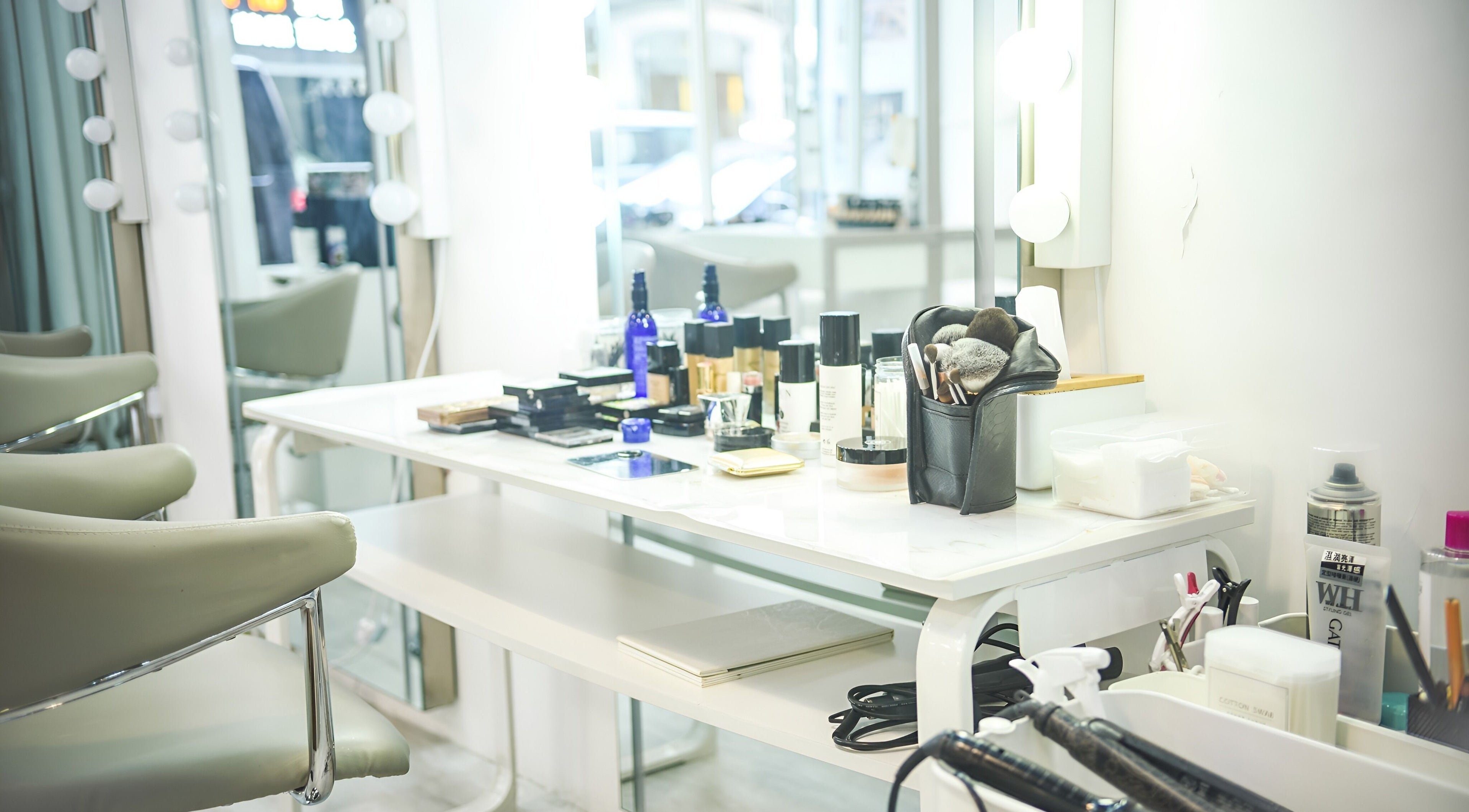 Elegant makeup station at Happy Face Photo Synthesis, Kowloon, HK, with beauty products and mirrors.