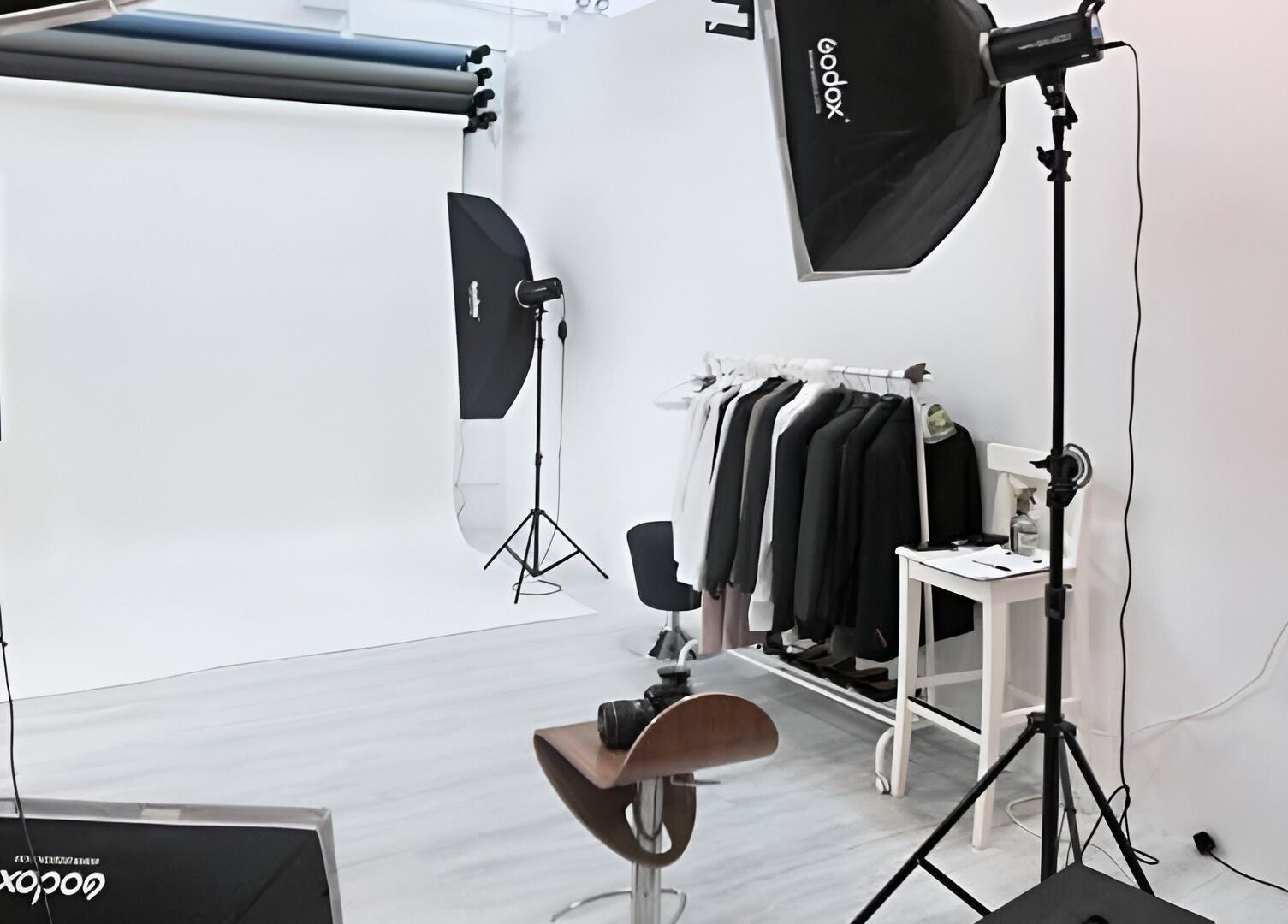Interior of Happy Face Photo Synthesis in Kowloon, HK, featuring professional photography setup and clothing rack.