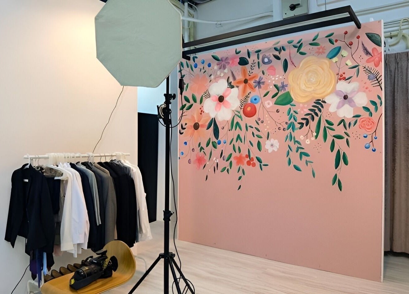 A floral-themed photo studio inside Happy Face Photo Synthesis, Kowloon, HK, with stylish clothing rack.