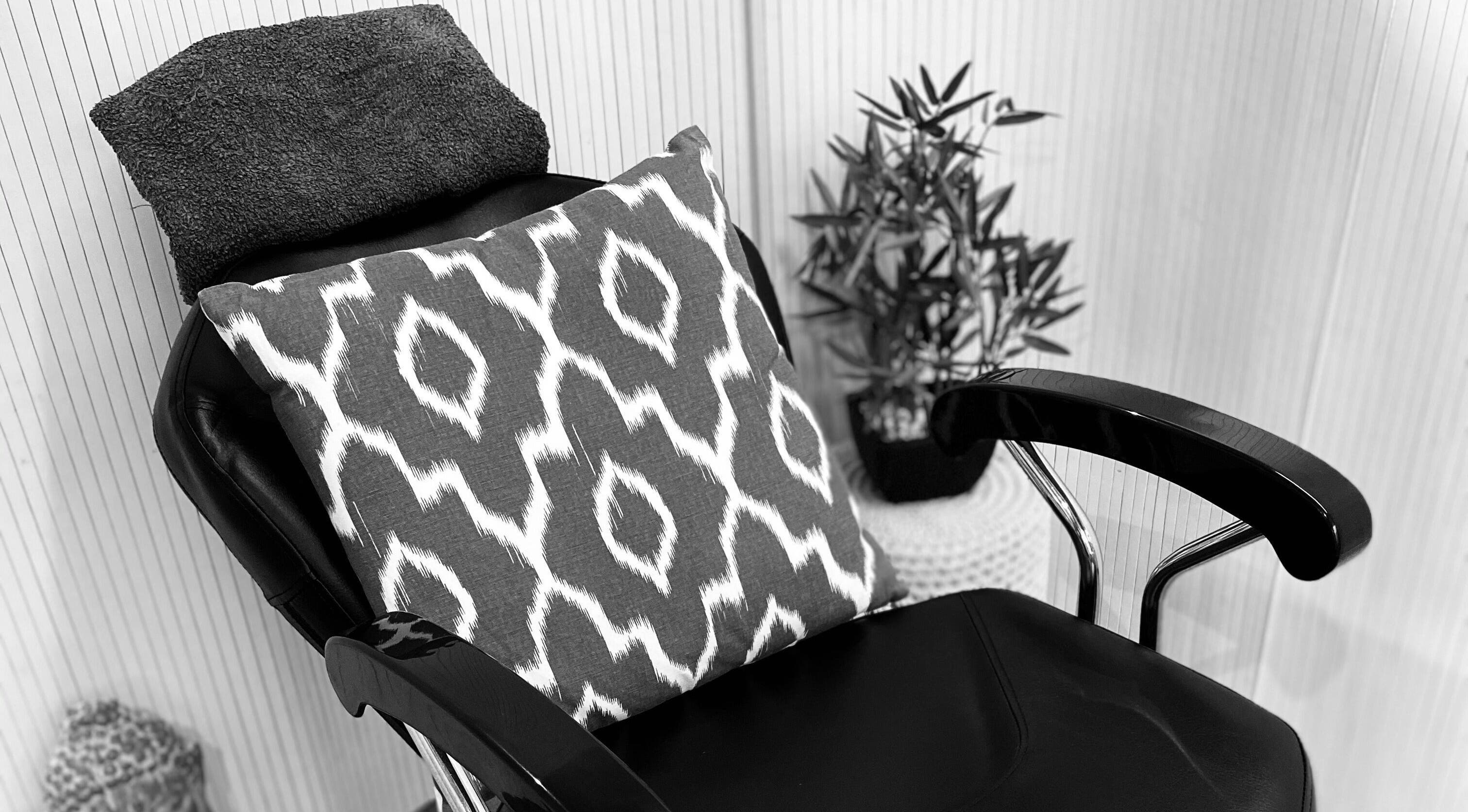 Elegant salon chair with patterned pillow at Adore Beauty, Yoxford, England, GB.