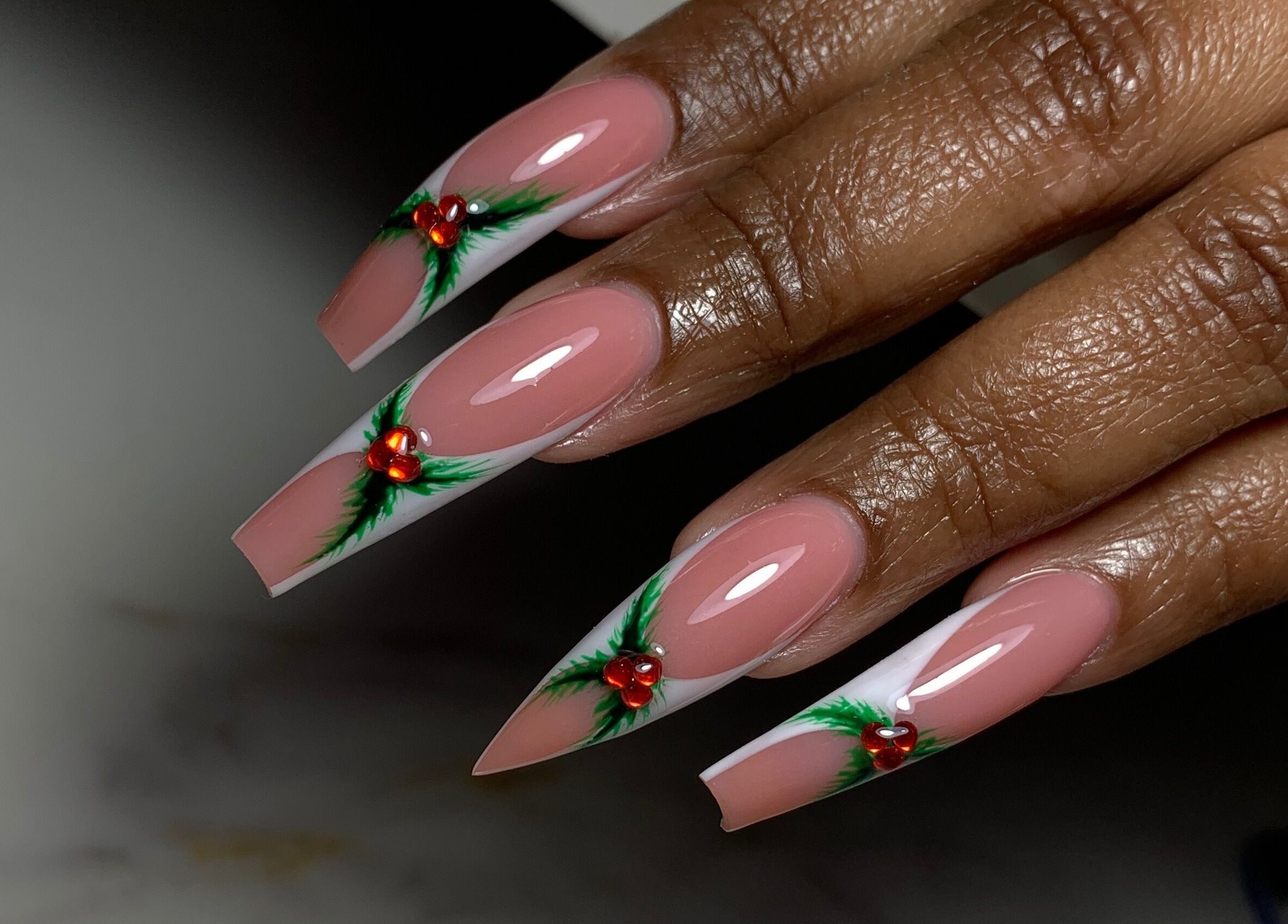 Elegant festive nail art with red and green accents, done at XxClusive Nails, Bridgetown, Saint Michael, BB.
