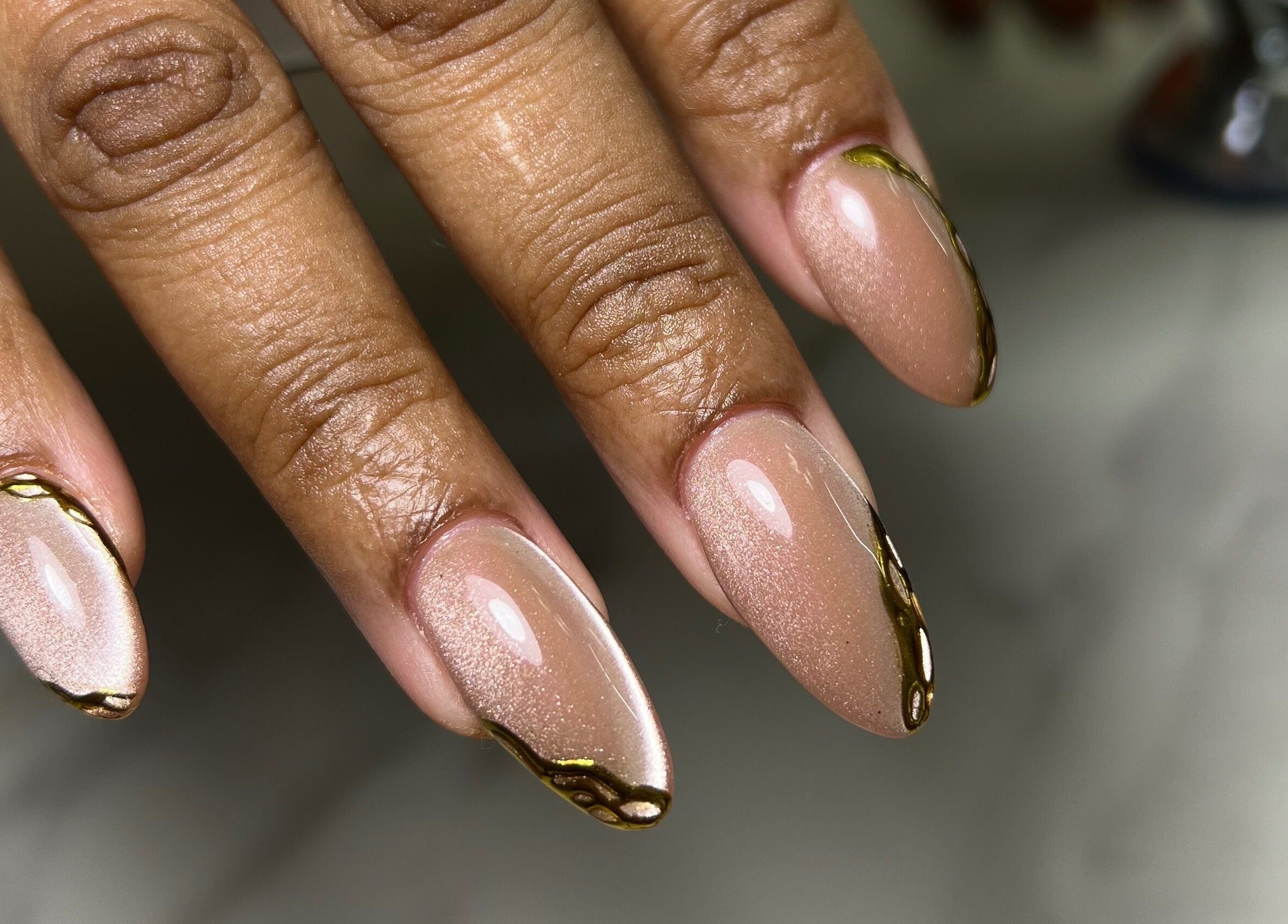 Elegant almond-shaped nails with gold accents at XxClusive Nails, Bridgetown, Saint Michael, BB.