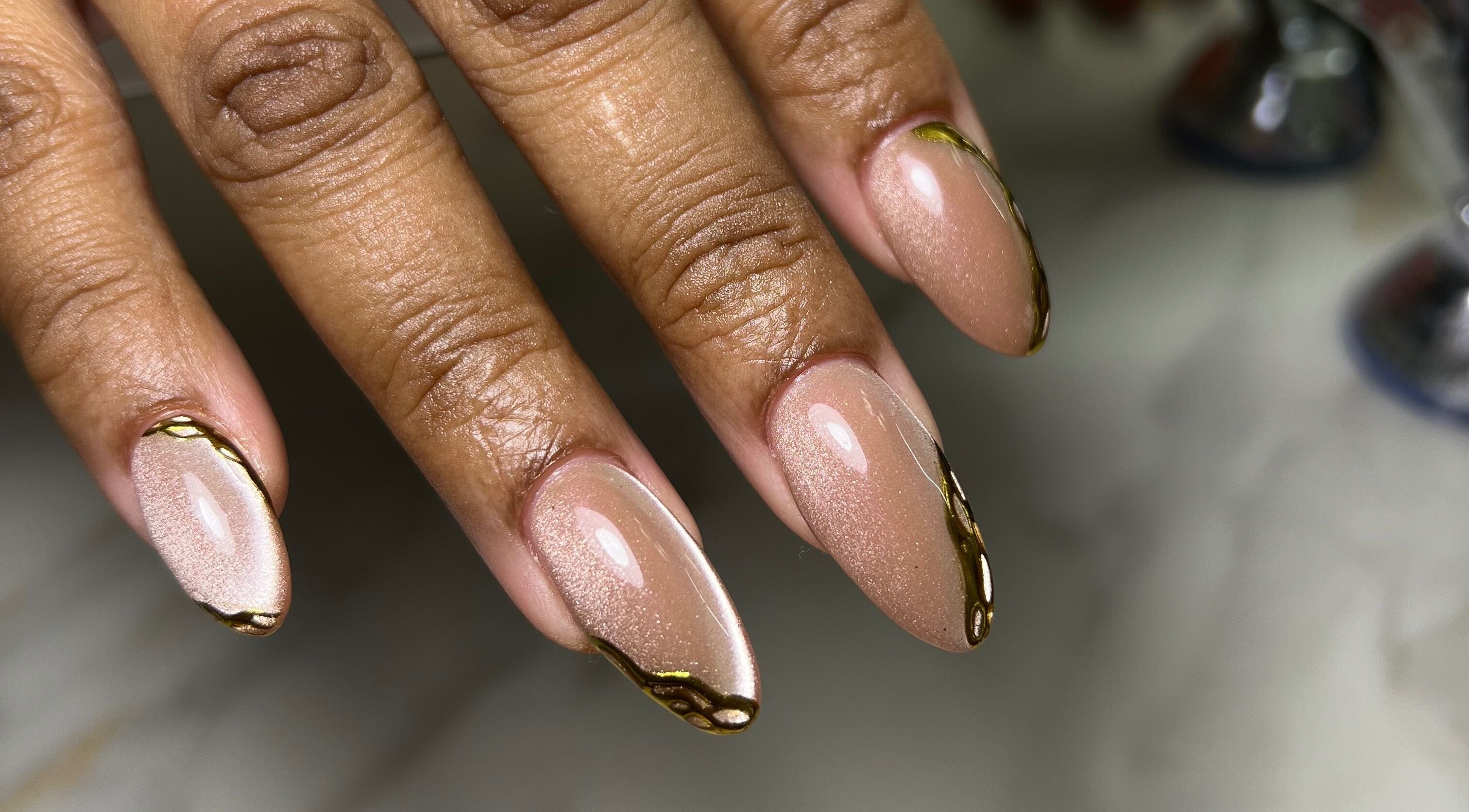 Elegant almond-shaped nails with gold accents at XxClusive Nails, Bridgetown, Saint Michael, BB.