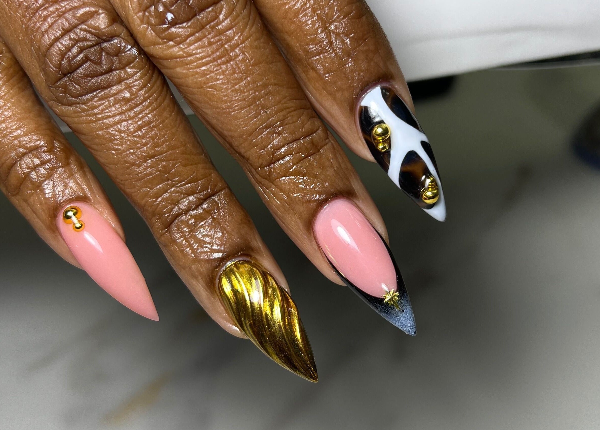 Elegant nail designs at XxClusive Nails in Bridgetown, Saint Michael, BB featuring gold and black accents.