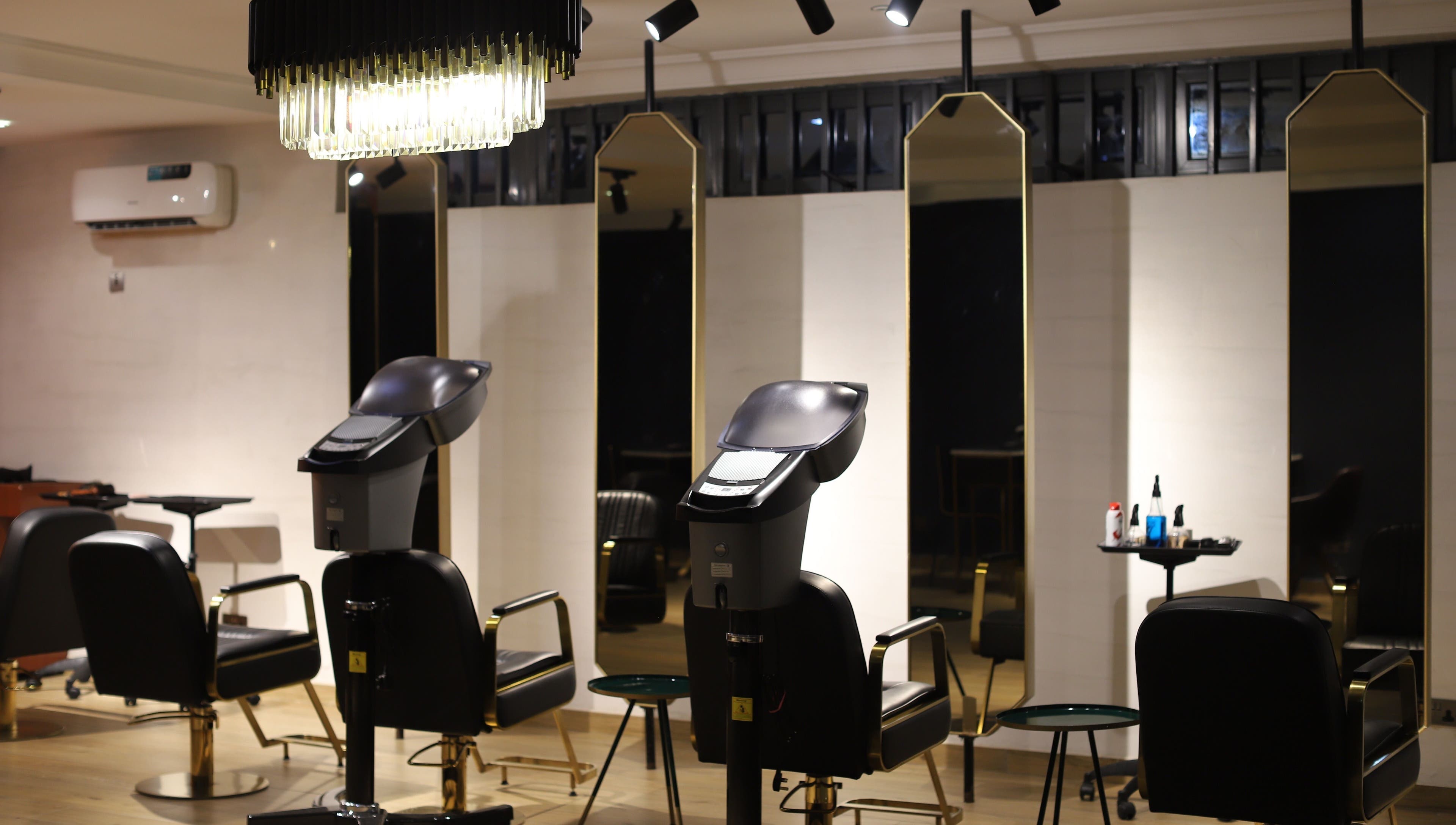 Chic hair styling stations at VstylesHair & Beauty Studio in Ikeja, Lagos, NG with modern decor and lighting.