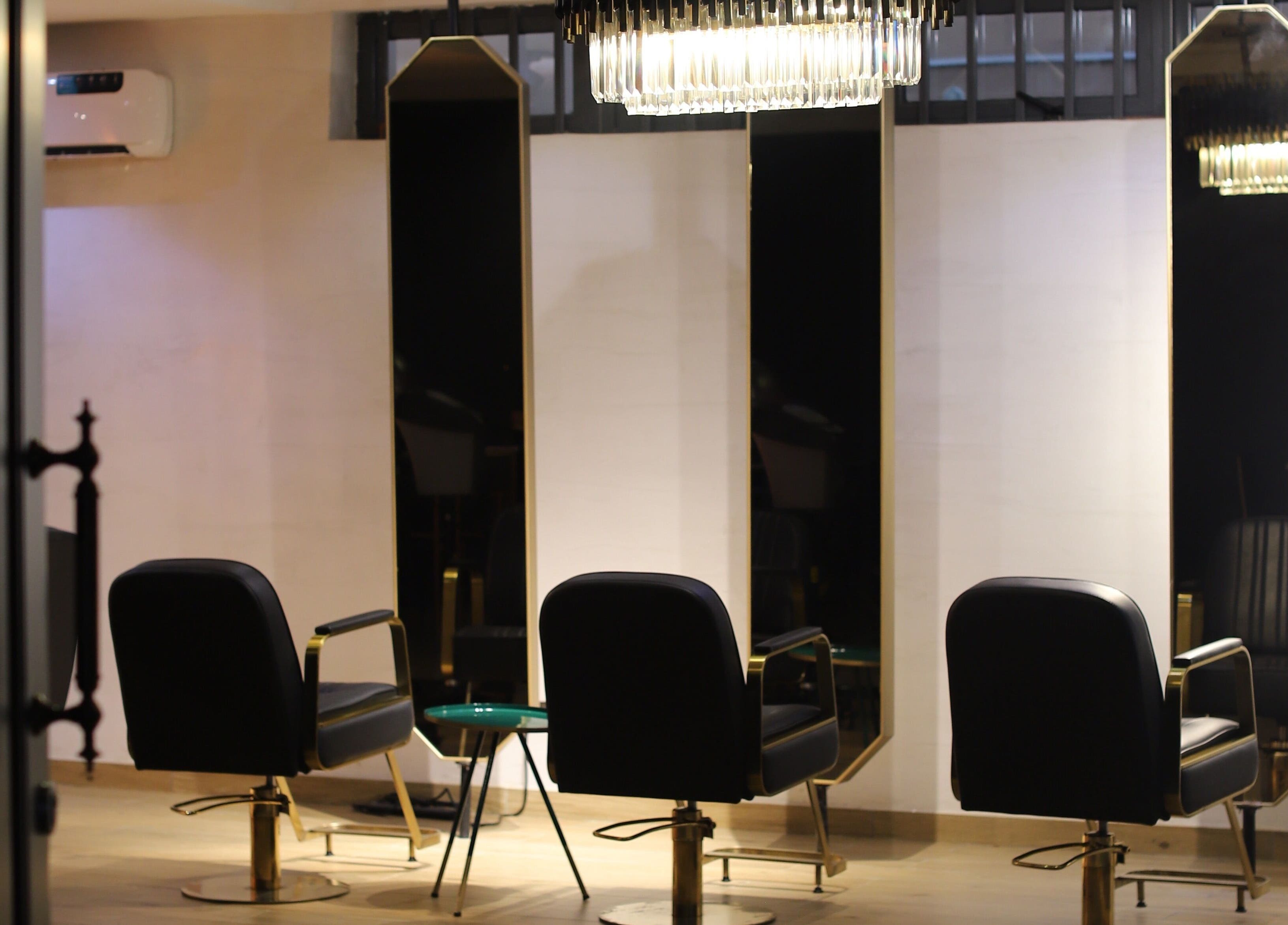 Chic interiors at VstylesHair & Beauty Studio, Ikeja, Lagos, NG, showcasing luxurious salon chairs and mirrors.
