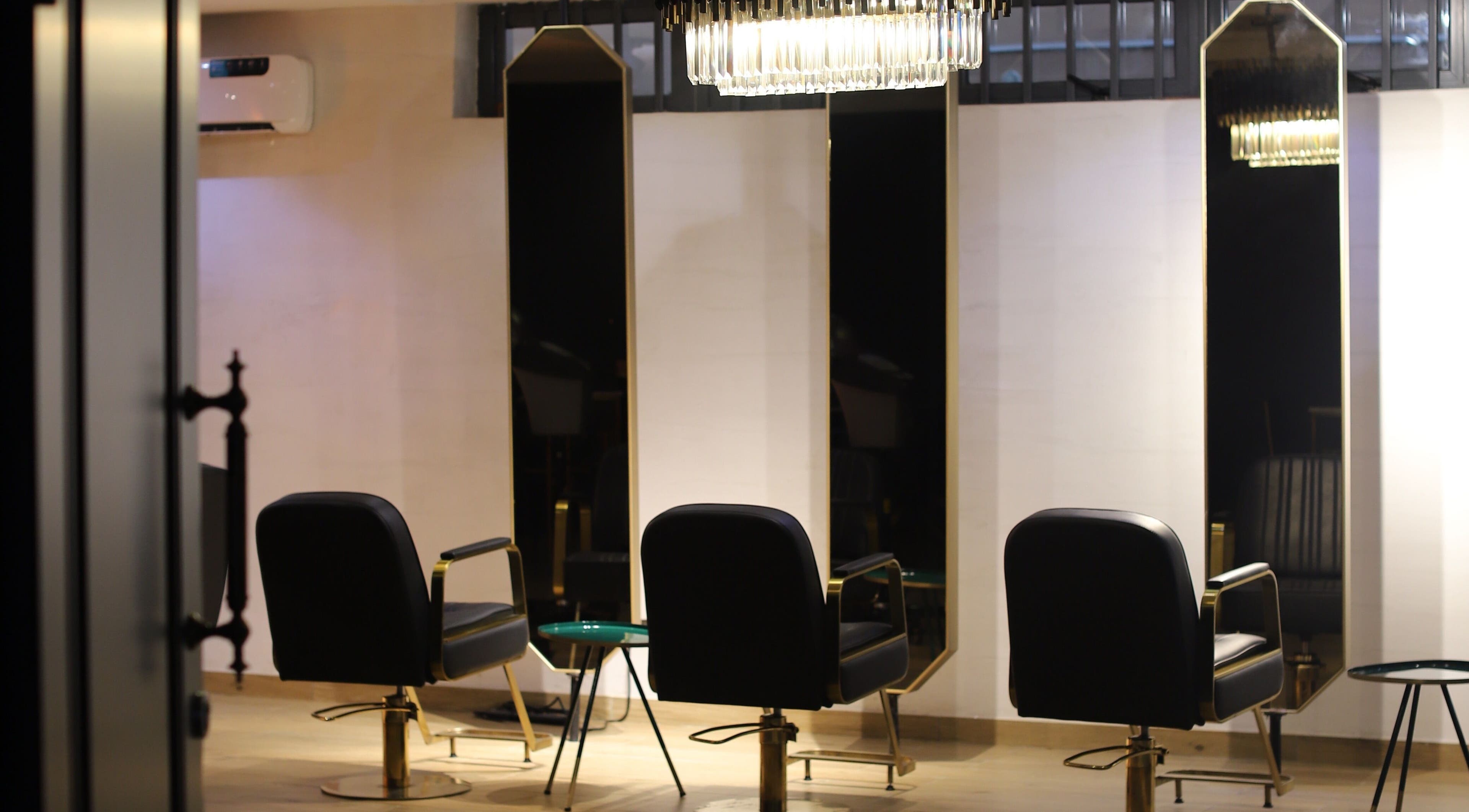 Chic interiors at VstylesHair & Beauty Studio, Ikeja, Lagos, NG, showcasing luxurious salon chairs and mirrors.