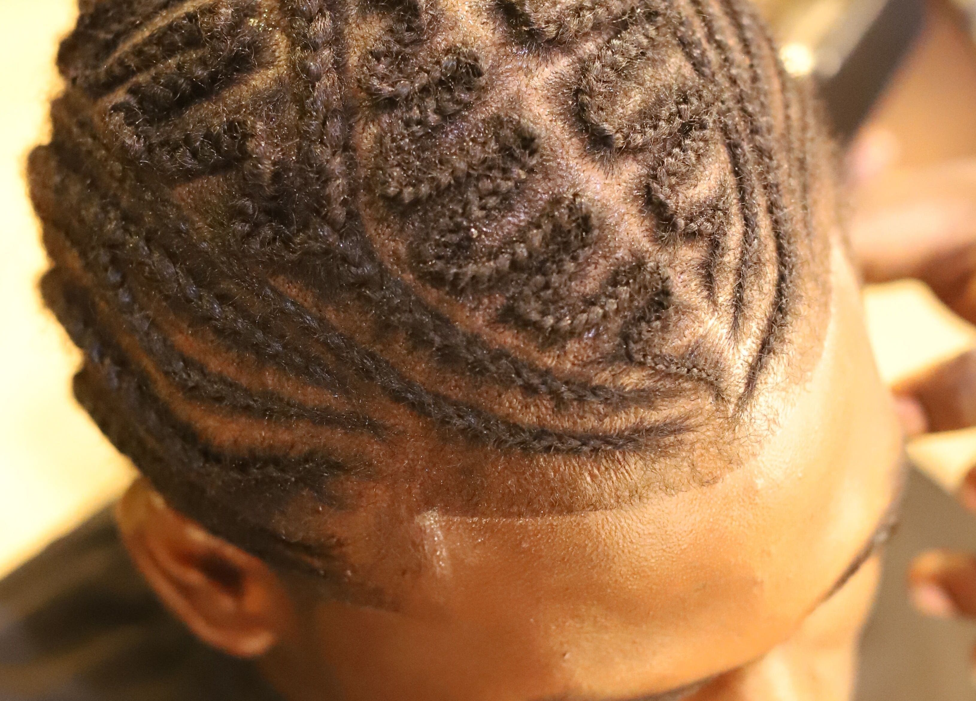 Intricate braided hairstyle at VstylesHair & Beauty Studio in Ikeja, Lagos, NG.