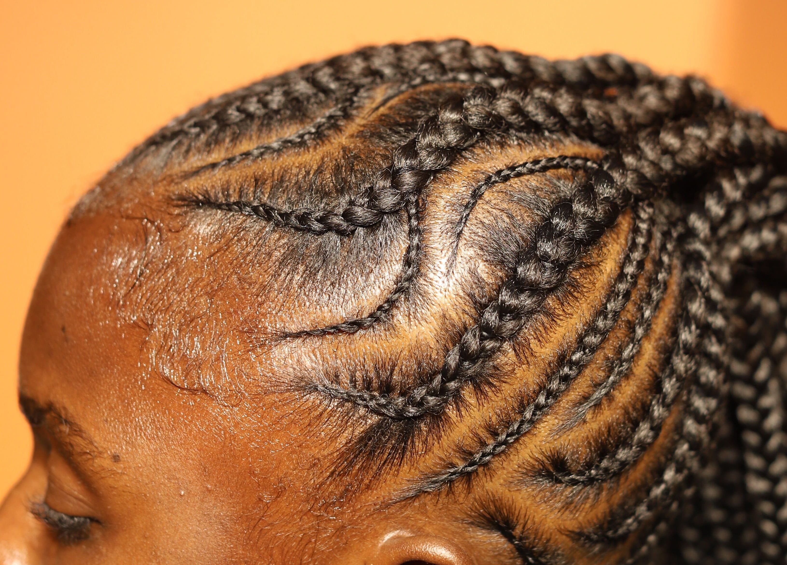 Intricate braided hairstyle at VstylesHair & Beauty Studio, Ikeja, Lagos, NG.