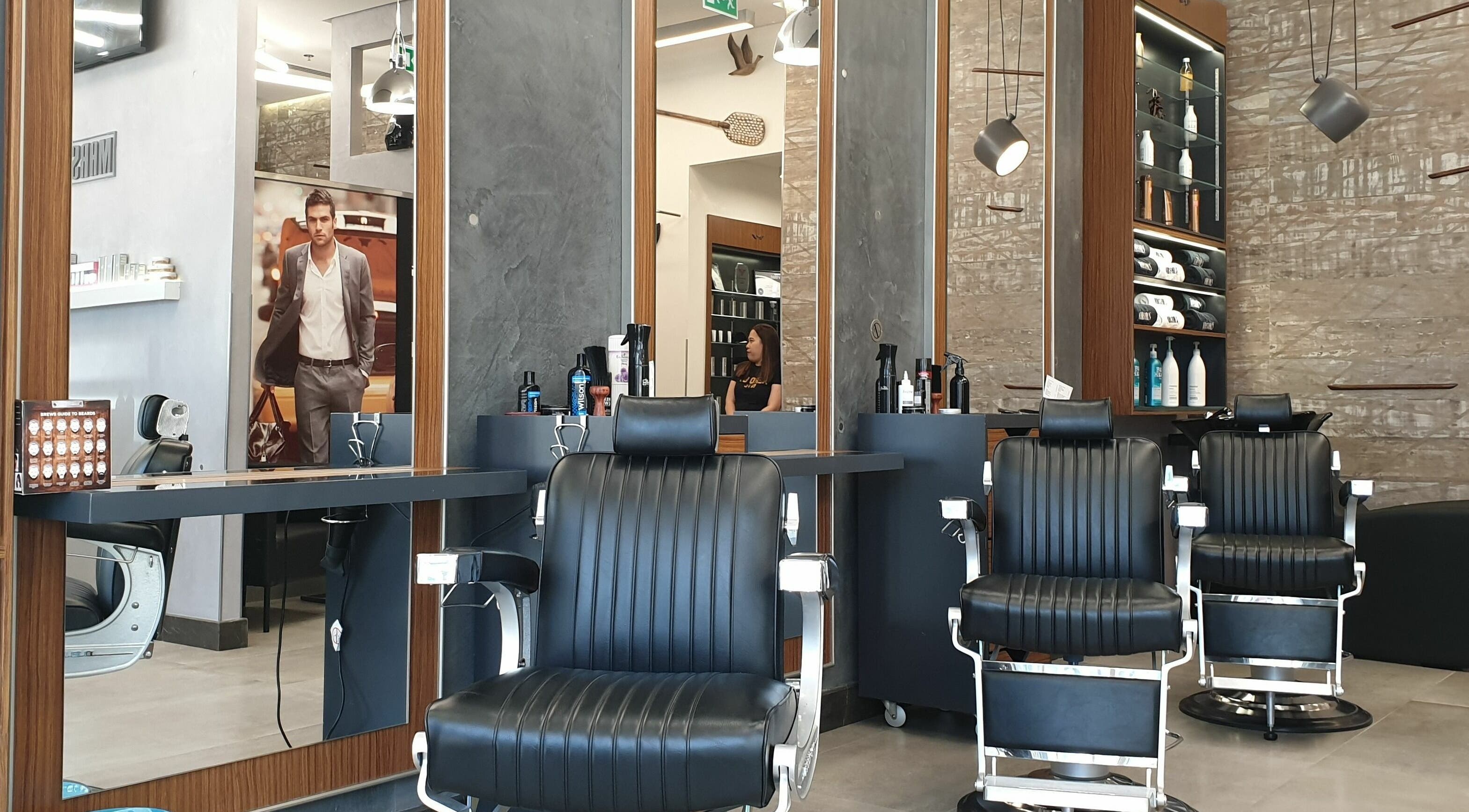 Elegant interior of Marshals Gents Salon in Dubai, Dubai, AE showcasing black barber chairs and modern decor.