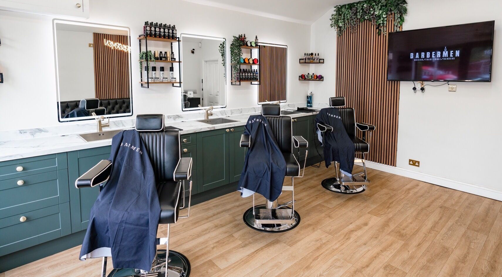 Elegant Barbermen interior with classic barber chairs and mirrors at Stoke-on-Trent, England, GB.