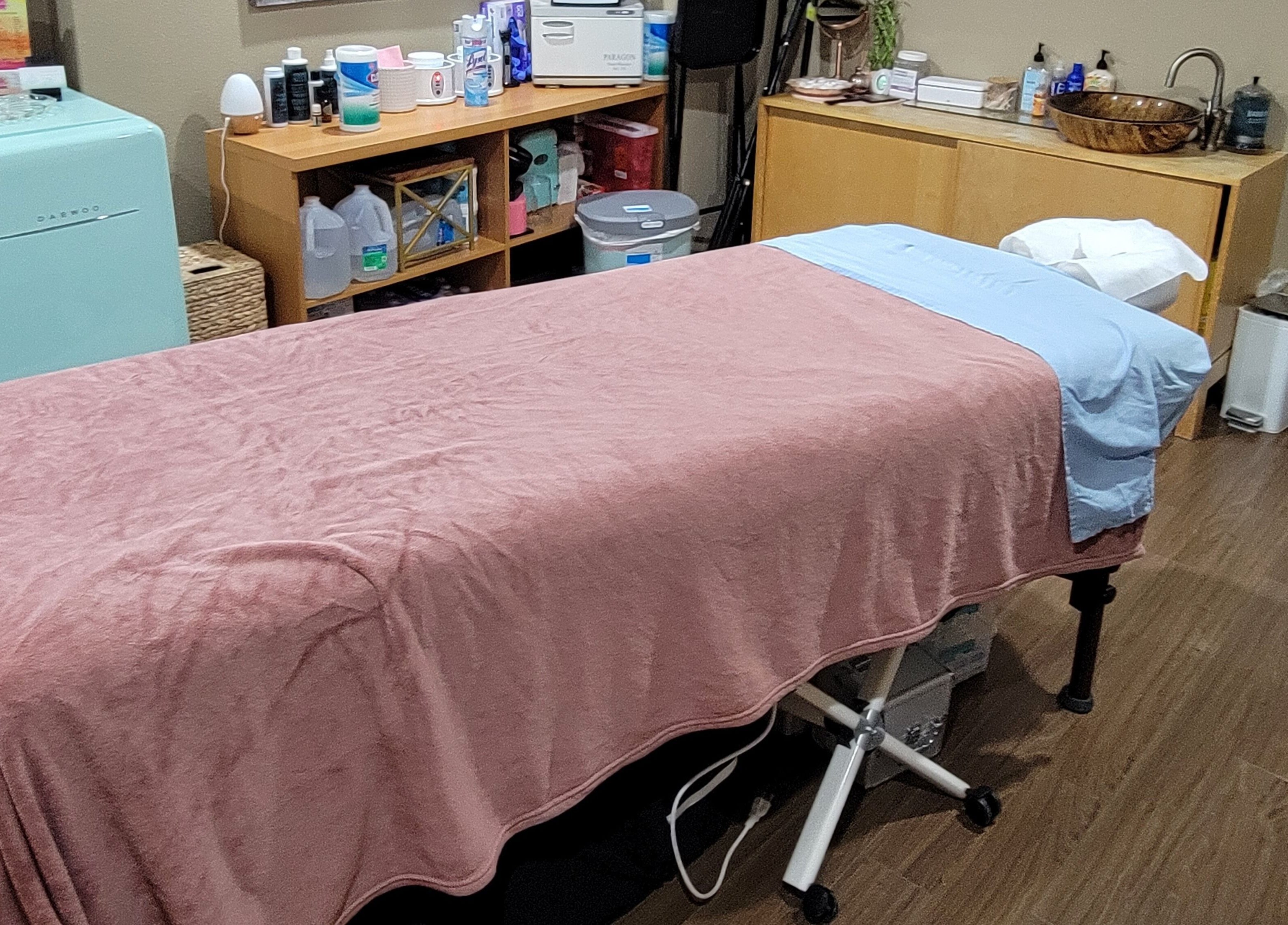 Cozy massage room at Rest, Relax, Rejoice Massage - LLC in Kent, Washington, US with a soft peach massage bed.