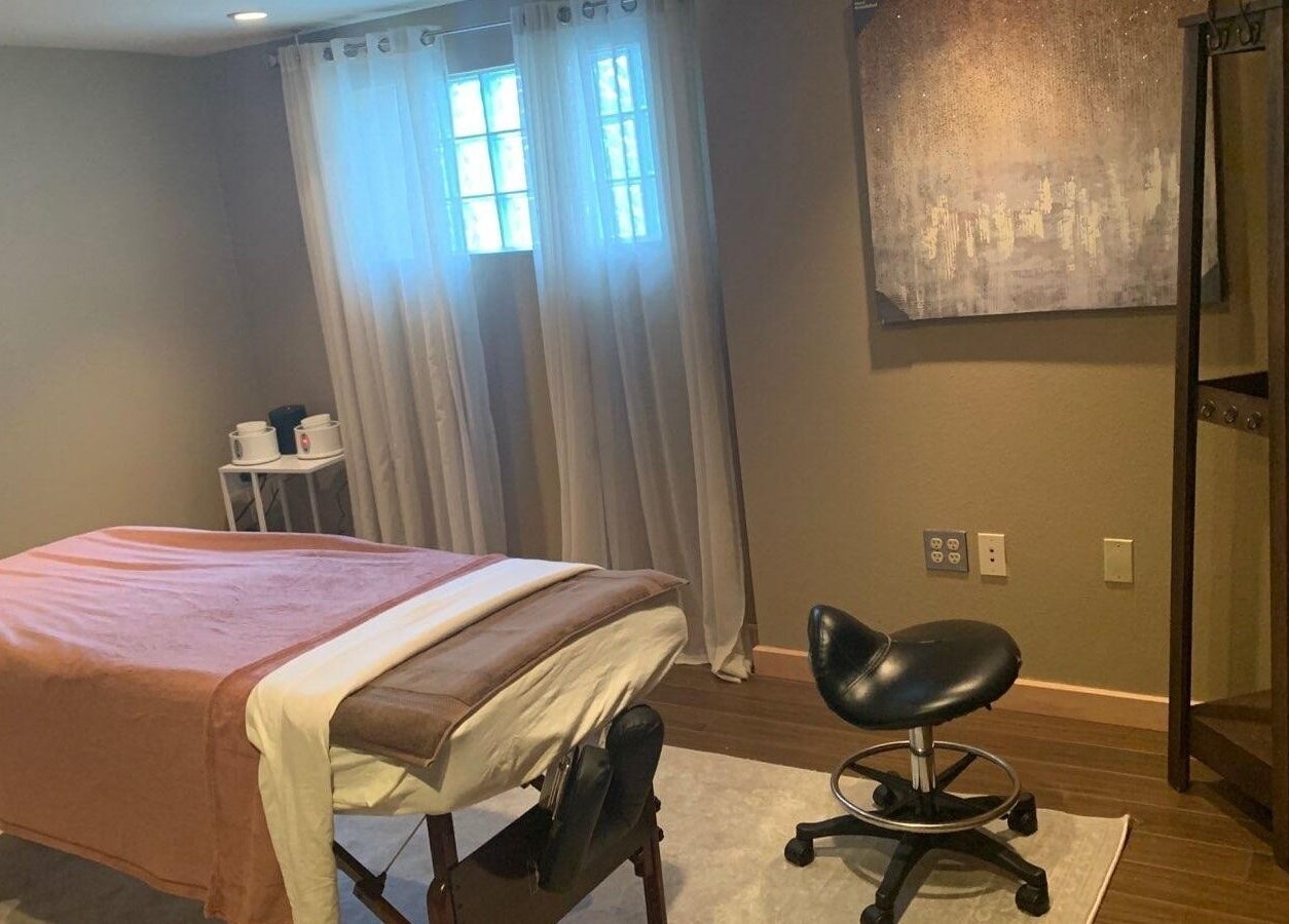 Relaxing massage room at Rest, Relax, Rejoice Massage, Auburn, Washington with calm lighting and cozy setup.