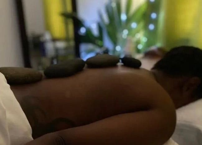 Relaxing hot stone massage at Open Beauty Divine Spa in Kingston, St. Andrew Parish, JM for ultimate relaxation.