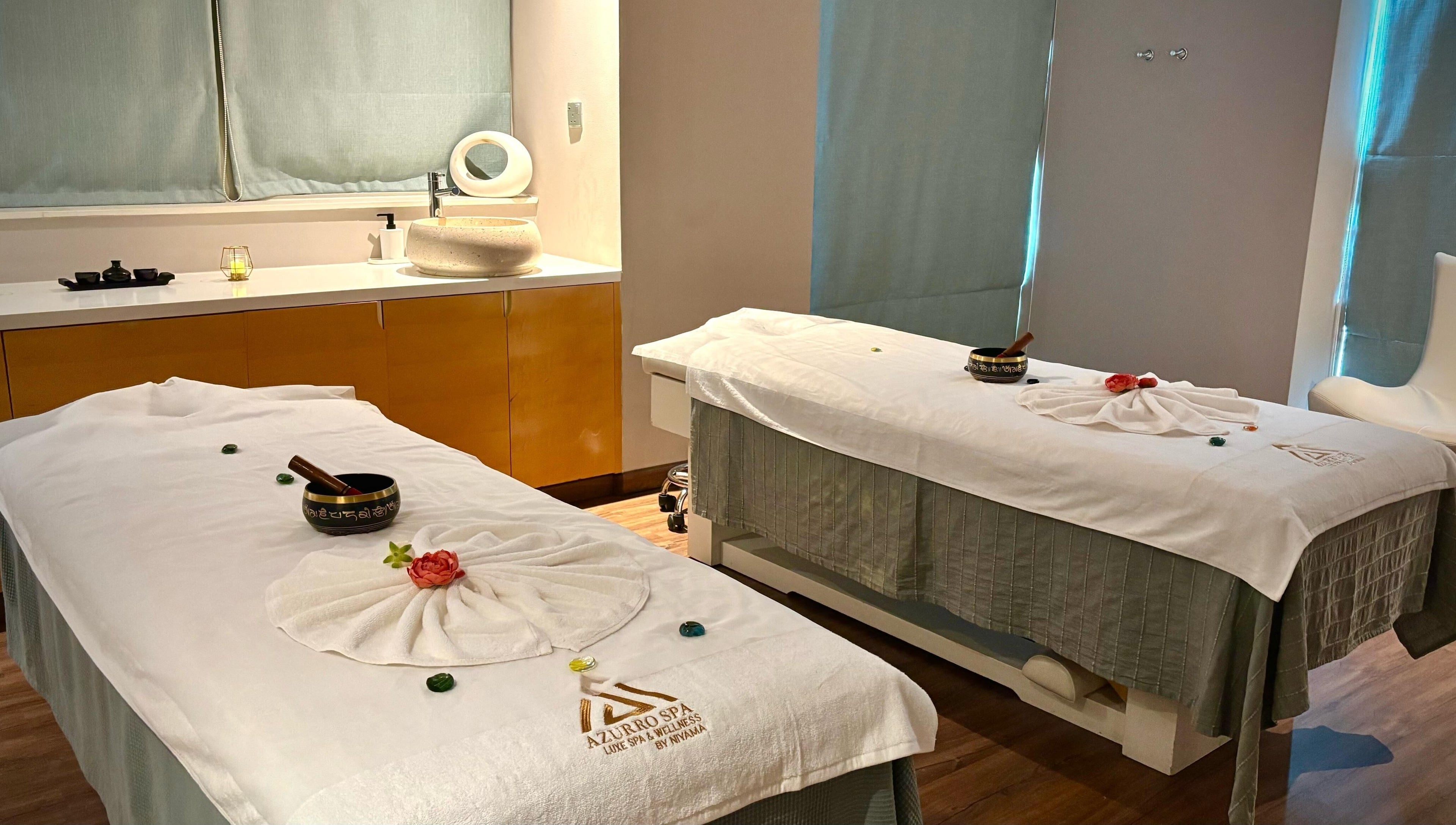 Relaxing massage room at Azurro Spa by Niyama - Pullman Hotel Jlt, Dubai, Dubai, AE with twin treatment tables.