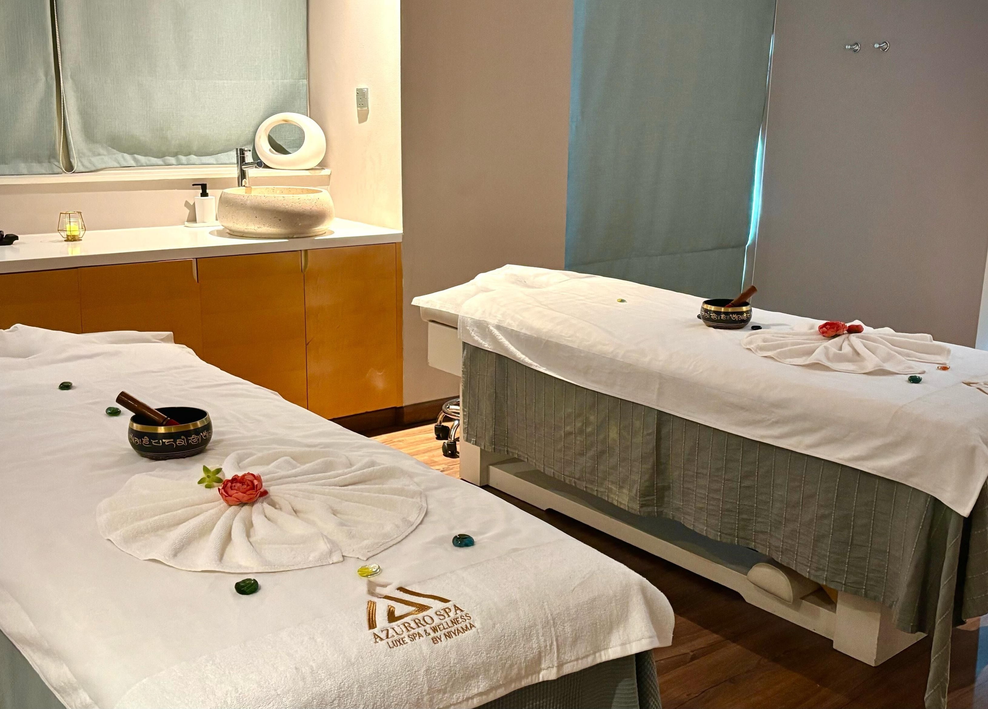 Relaxing massage room at Azurro Spa by Niyama - Pullman Hotel Jlt, Dubai, Dubai, AE with twin treatment tables.