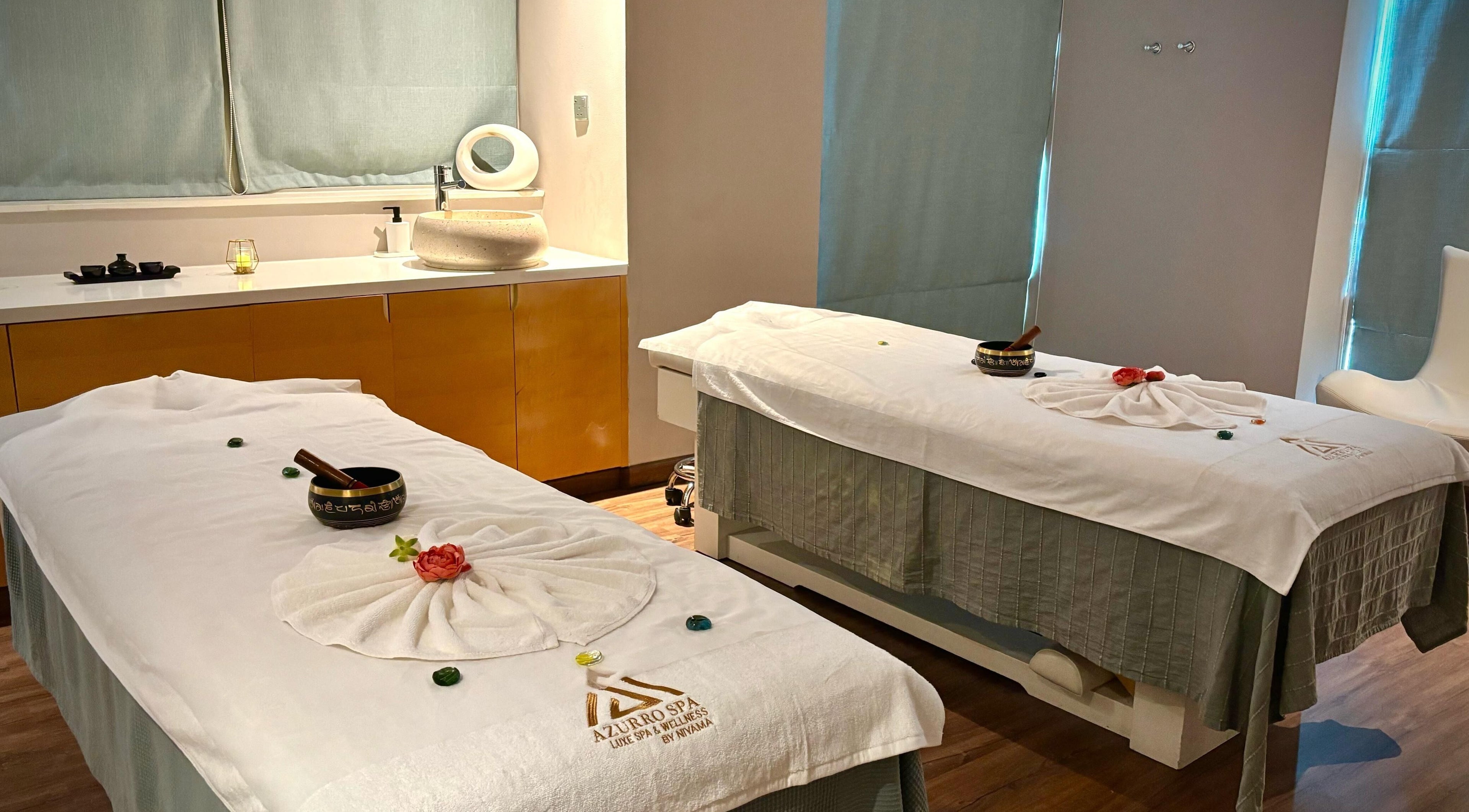 Relaxing massage room at Azurro Spa by Niyama - Pullman Hotel Jlt, Dubai, Dubai, AE with twin treatment tables.