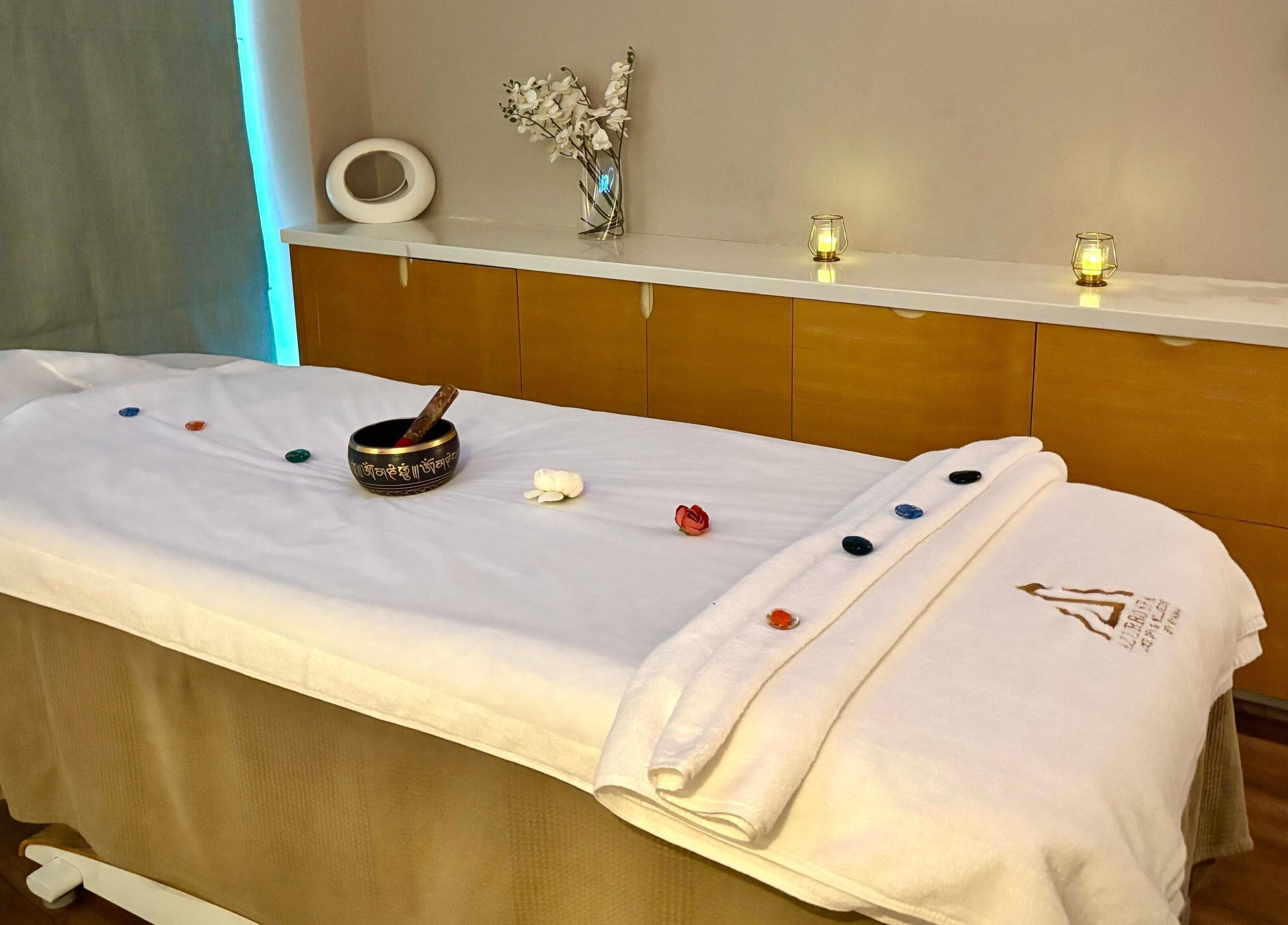 Massage table at Azurro Spa by Niyama - Pullman Hotel Jlt, Dubai, Dubai, AE, adorned with candles and decor.