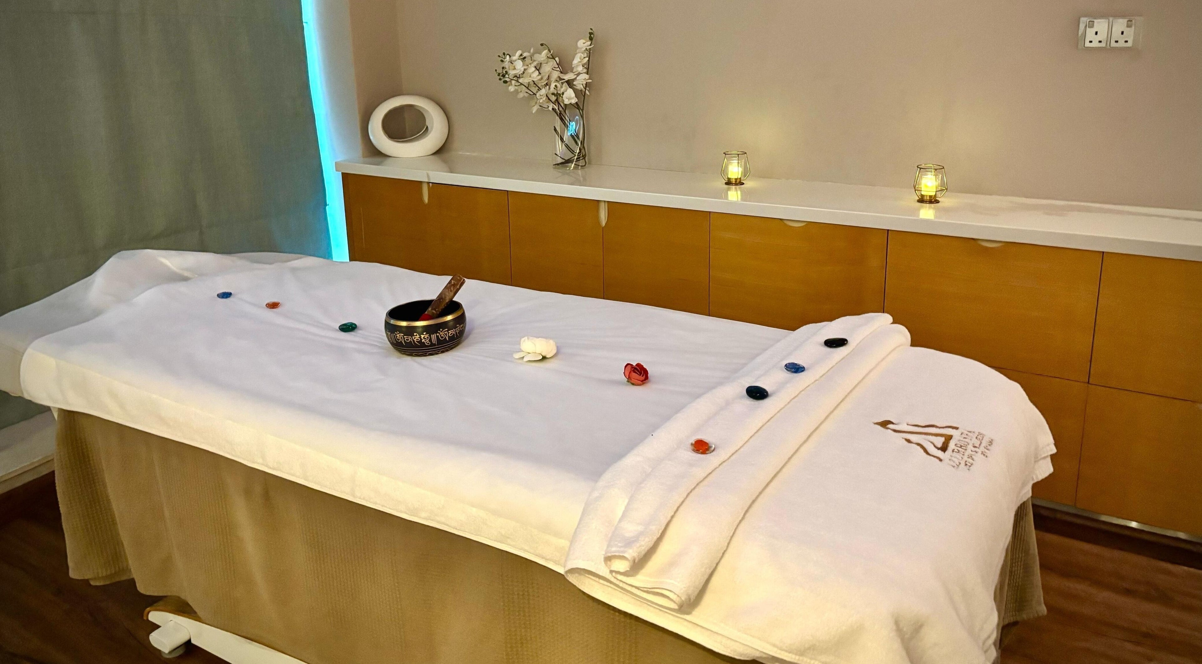 Massage table at Azurro Spa by Niyama - Pullman Hotel Jlt, Dubai, Dubai, AE, adorned with candles and decor.