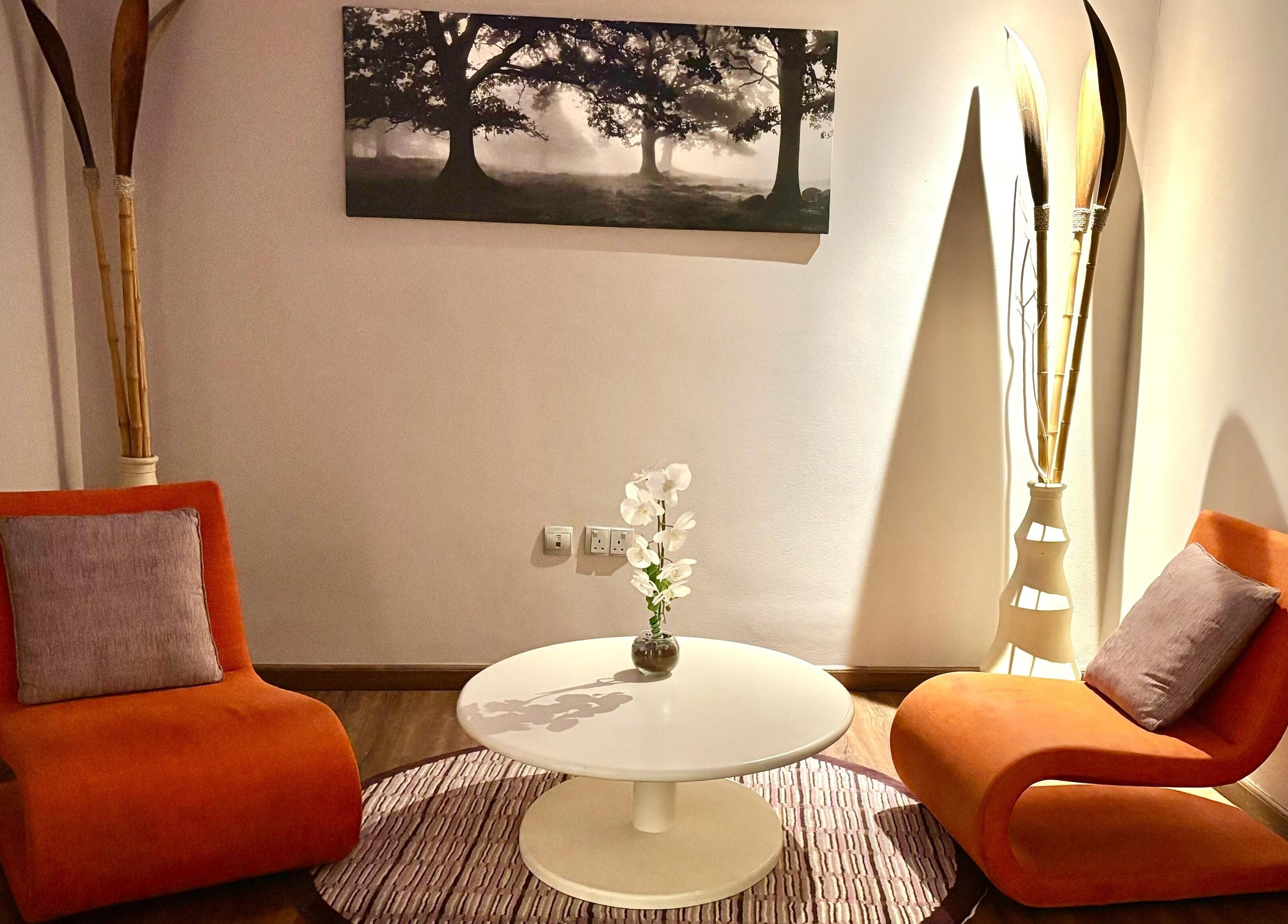 Elegant waiting area at Azurro Spa by Niyama - Pullman Hotel Jlt, Dubai. Cozy chairs and table create a relaxing ambiance.