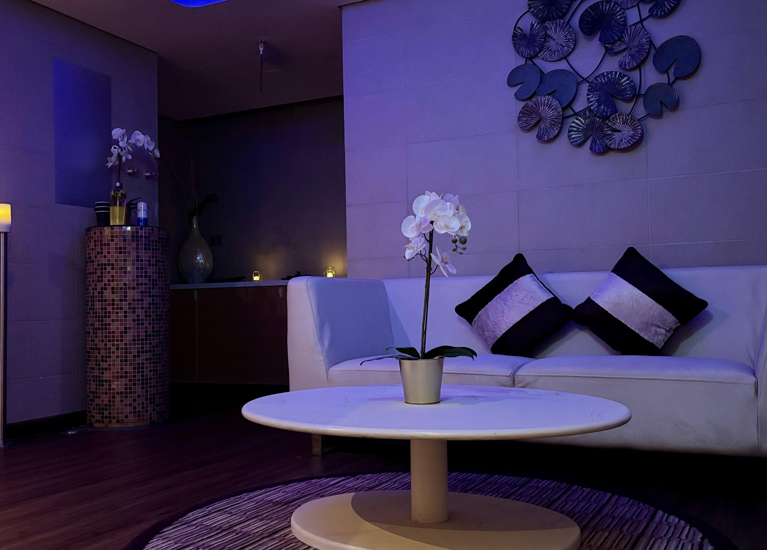 Elegant spa lounge at Azurro Spa by Niyama - Pullman Hotel Jlt, Dubai, Dubai, AE with candles and orchids.