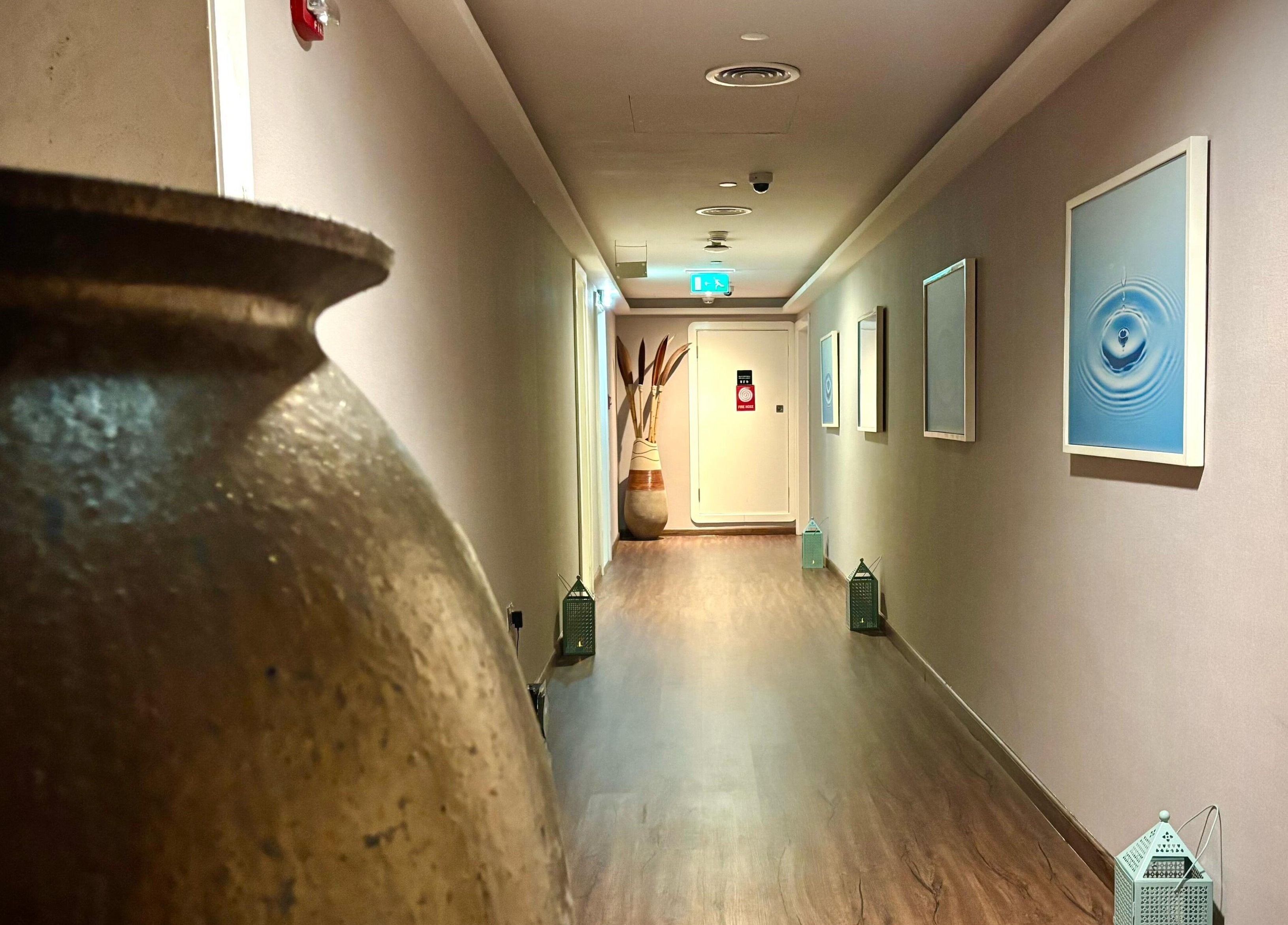 Elegant hallway at Azurro Spa by Niyama - Pullman Hotel Jlt, Dubai, AE with art and decorative elements.