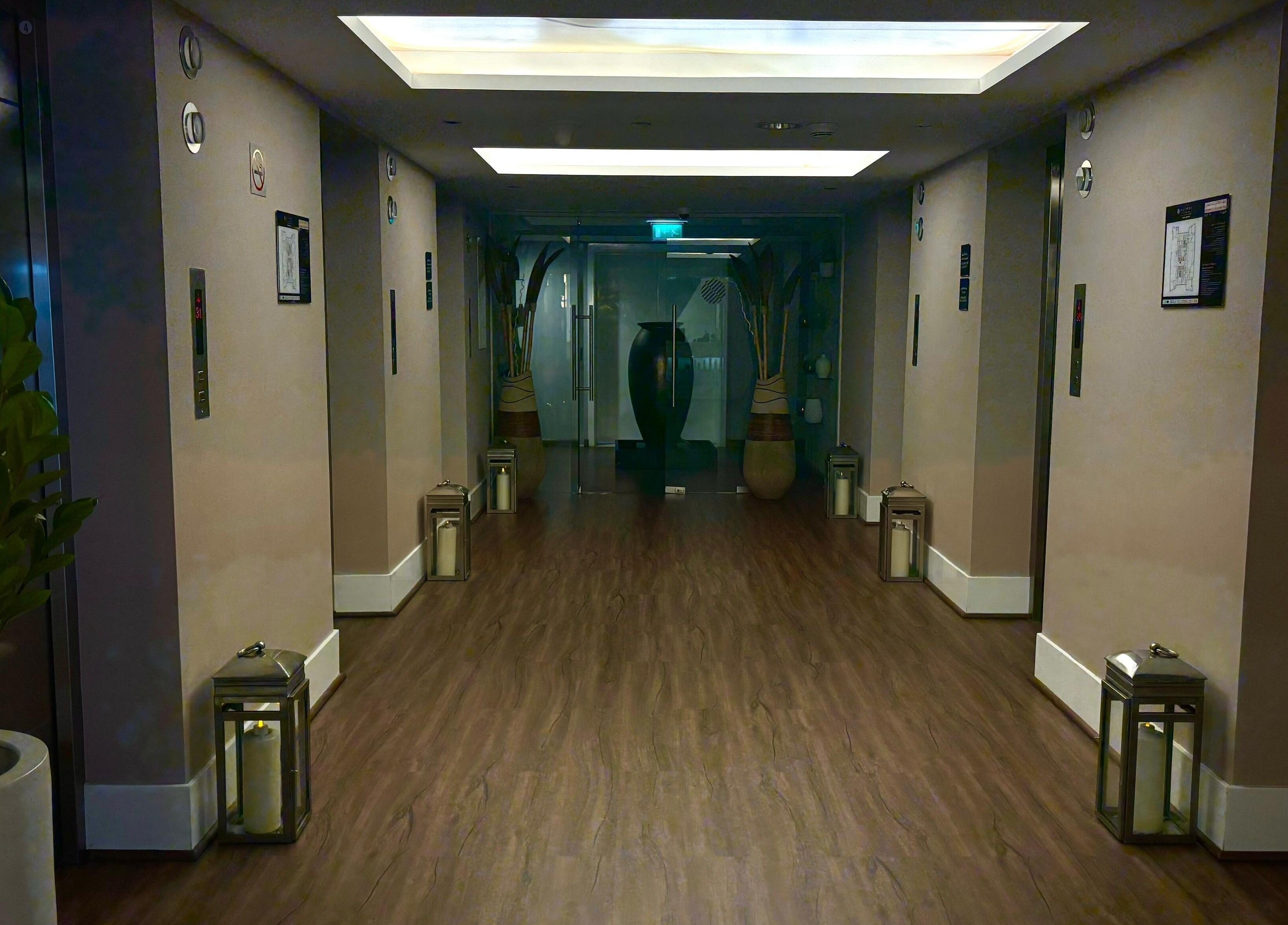 Elegant hallway at Azurro Spa by Niyama - Pullman Hotel Jlt, Dubai, Dubai, AE with soft lighting and decor.