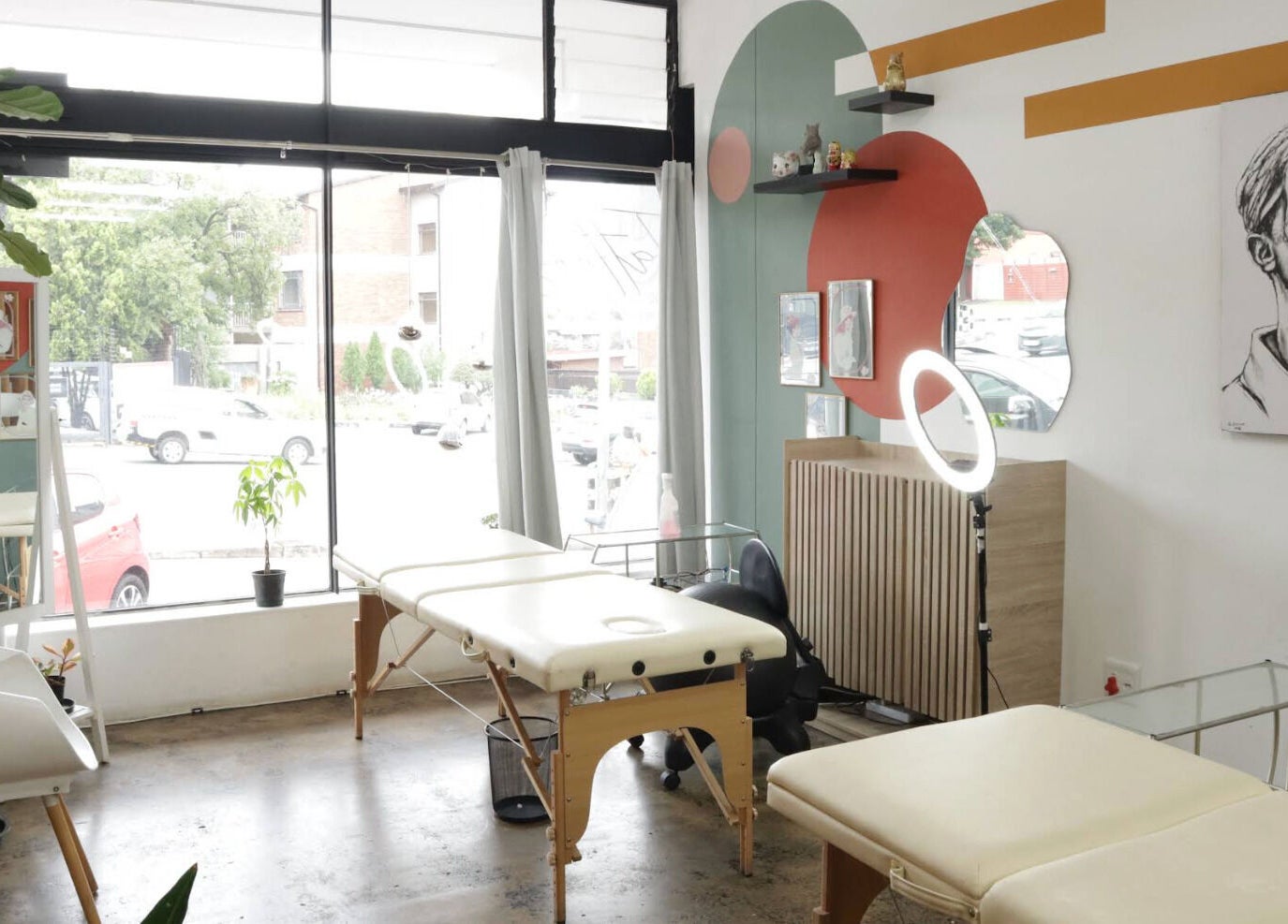 Bright, modern interior of Olive and Co. Studios, Randburg, Gauteng, ZA with sleek design and massage tables.
