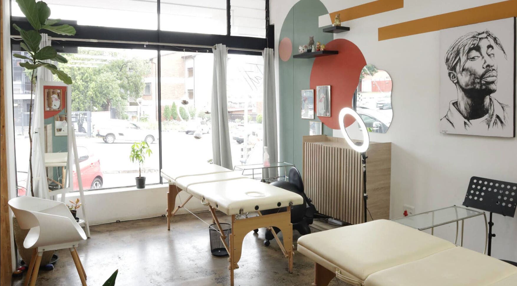 Bright, modern interior of Olive and Co. Studios, Randburg, Gauteng, ZA with sleek design and massage tables.