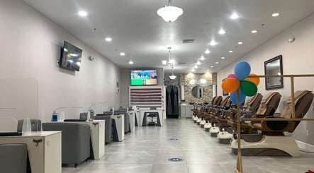 Modern interior of Helen's Nails & Spa, Wildwood, Florida, US, with sleek nail stations and pedicure chairs.