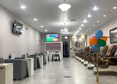 Spacious interior of Helen's Nails & Spa in Wildwood, Florida, US, featuring cozy pedicure chairs and bright decor.