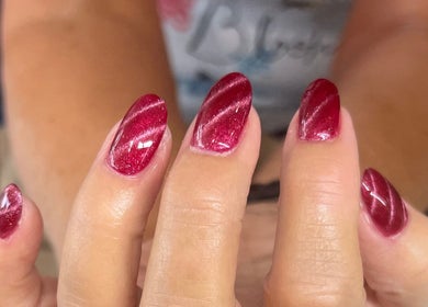 Elegant crimson nails at Helen's Nails & Spa, Wildwood, Florida, US showcasing expert manicure artistry.