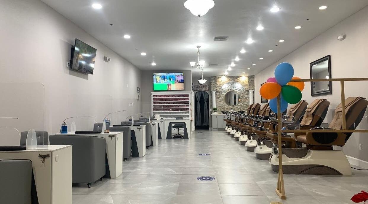 Stylish interior of Helen's Nails & Spa in Wildwood, Florida, US with pedicure chairs and nail stations.