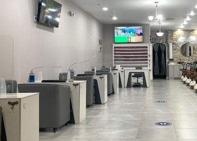 Bright interior of Helen's Nails & Spa in Wildwood, Florida, US with elegant pedicure and manicure stations.