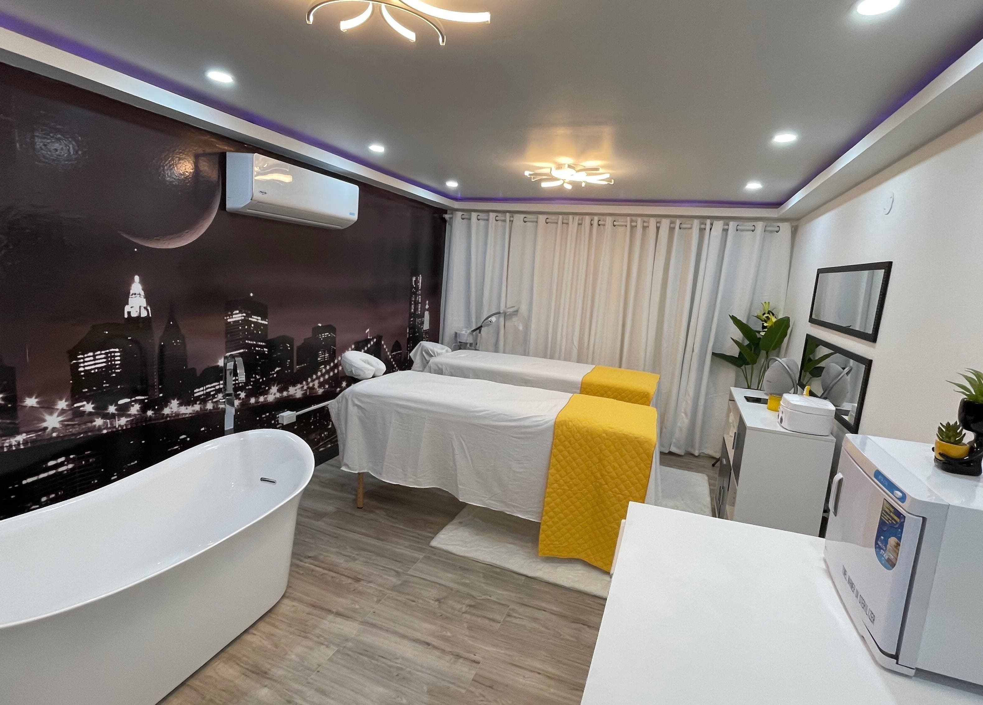 Elegant spa room at Beauty Statement Salon & Spa, Ocho Rios, JM featuring massage tables and a modern bathtub.