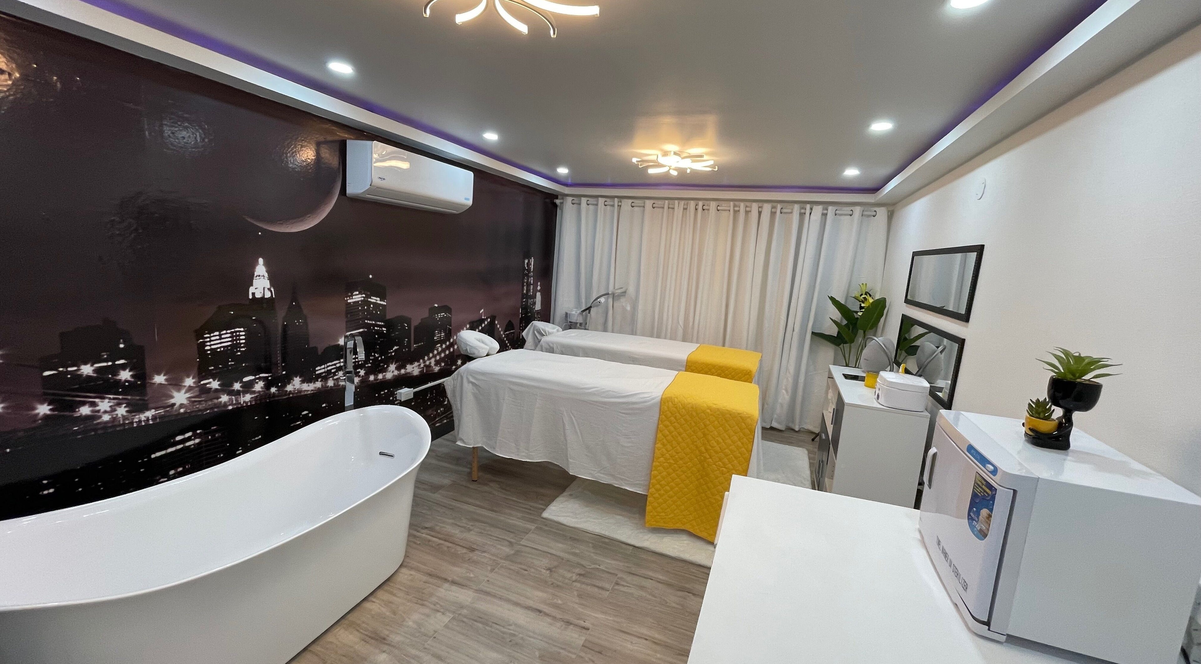 Elegant spa room at Beauty Statement Salon & Spa, Ocho Rios, JM featuring massage tables and a modern bathtub.