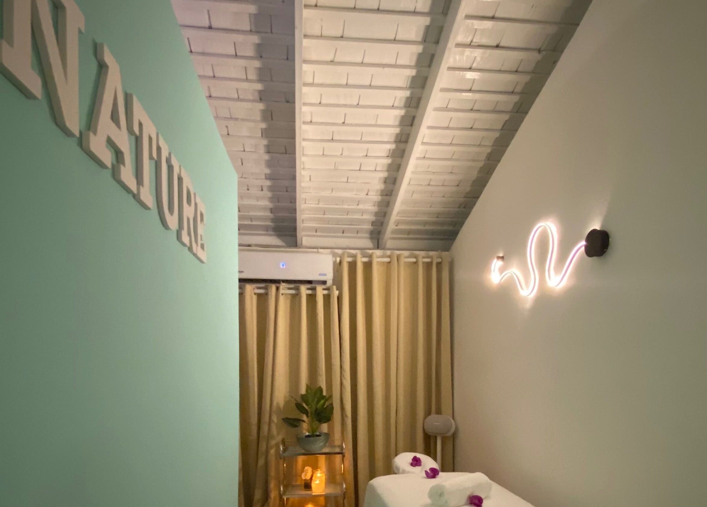 Calming massage room at Beauty Statement Salon & Spa, Ocho Rios, JM, with soft lighting and decor.