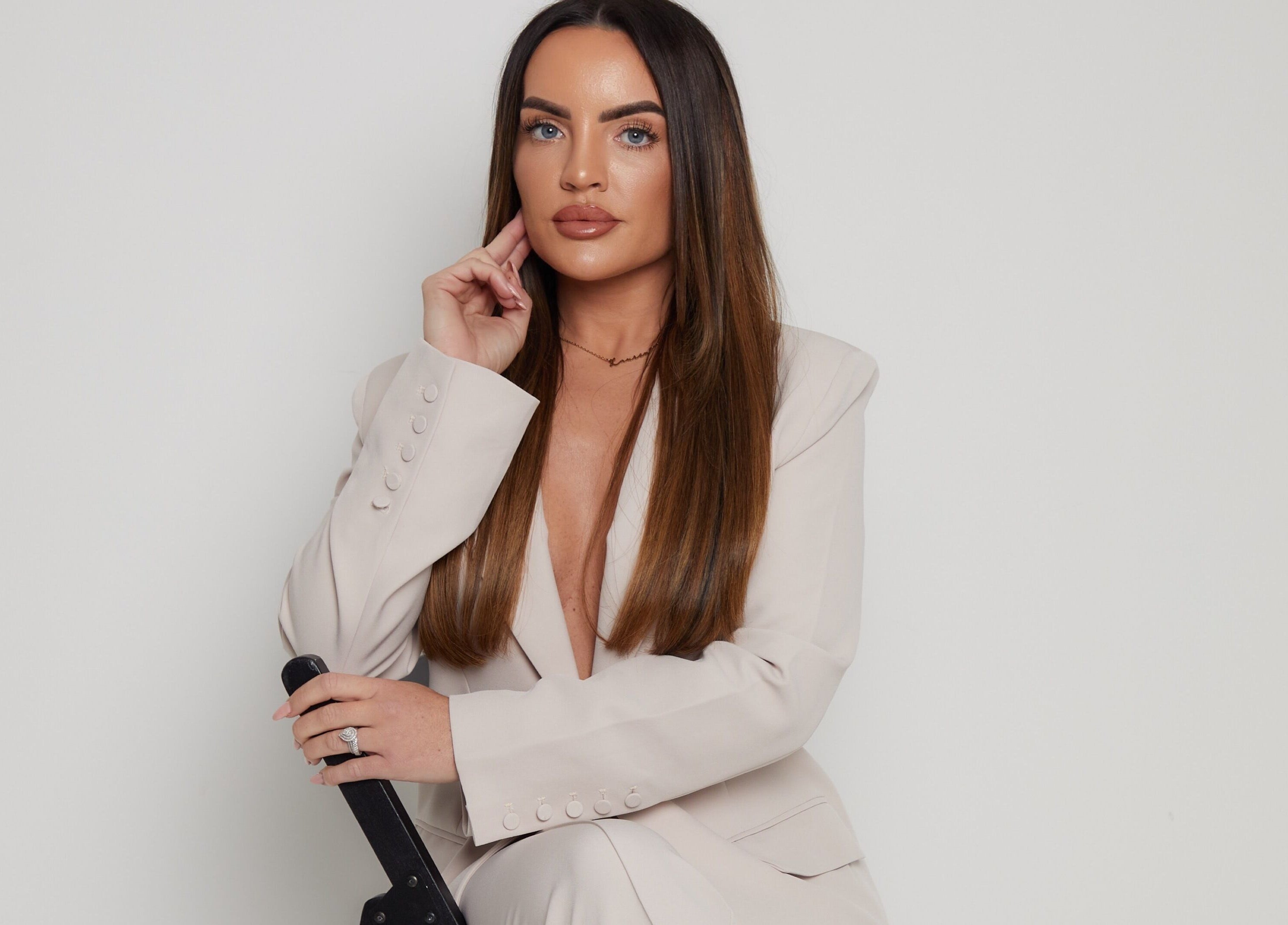 A stylish professional in a cream blazer at Lauren Cosmetic Aesthetics, Wigan, England, GB.