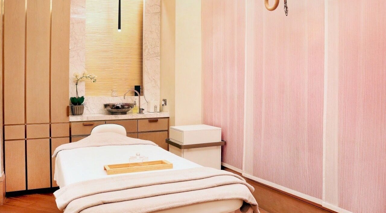 Luxurious massage room at The M Spa, Dubai, Dubai, AE, featuring a cozy table and elegant decor.