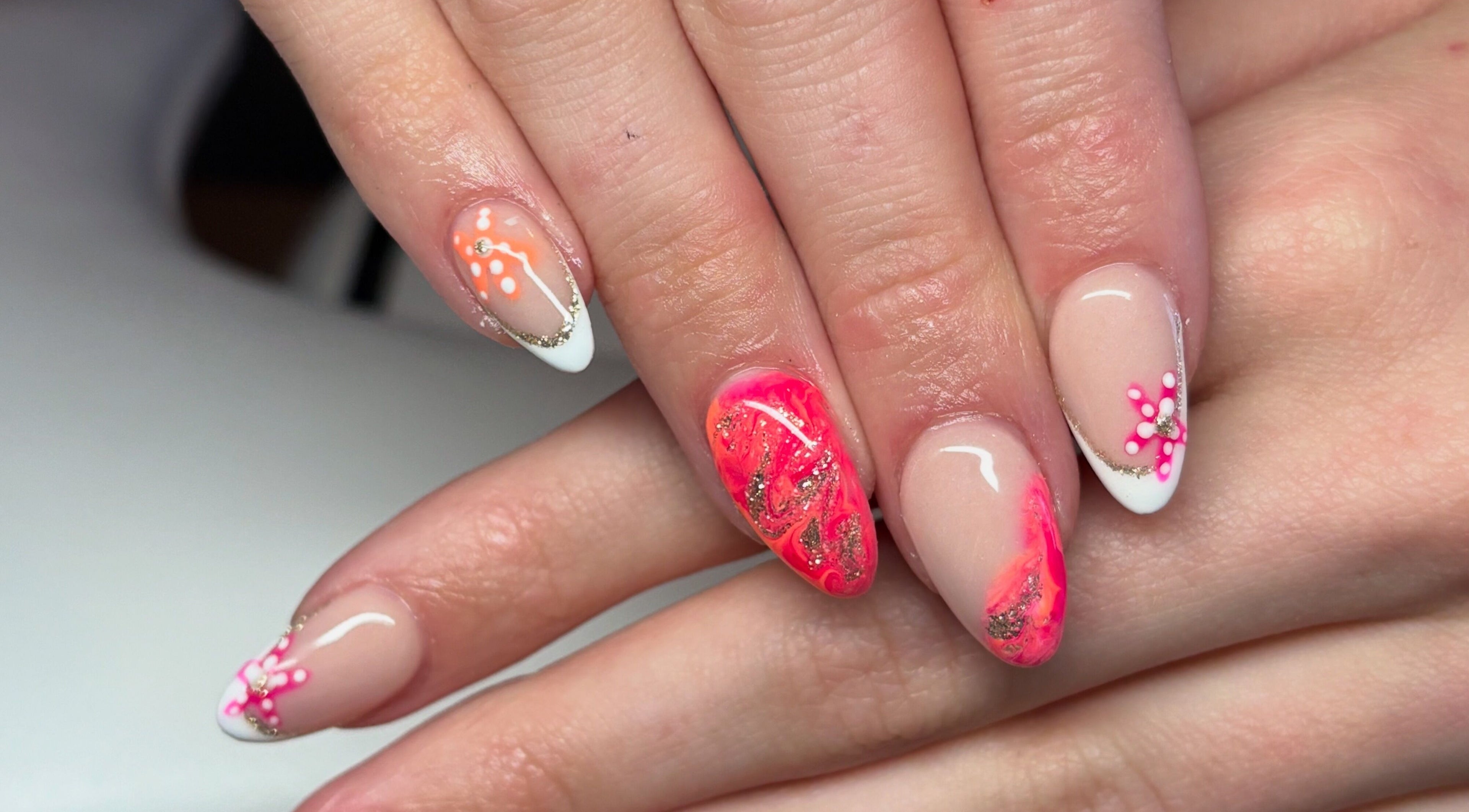 Stylish nail art with pink and orange details at The Boujee Nail Club, Bathgate, Scotland, GB.