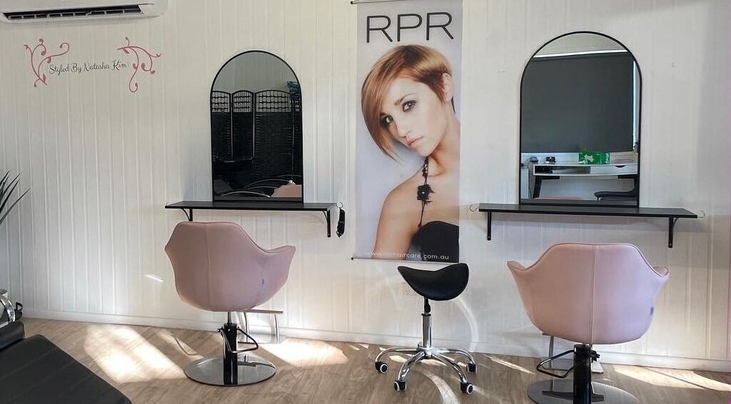 Chic interior of Hair By Natasha Kim, Millbank, Queensland, AU with mirrors and stylish chairs.