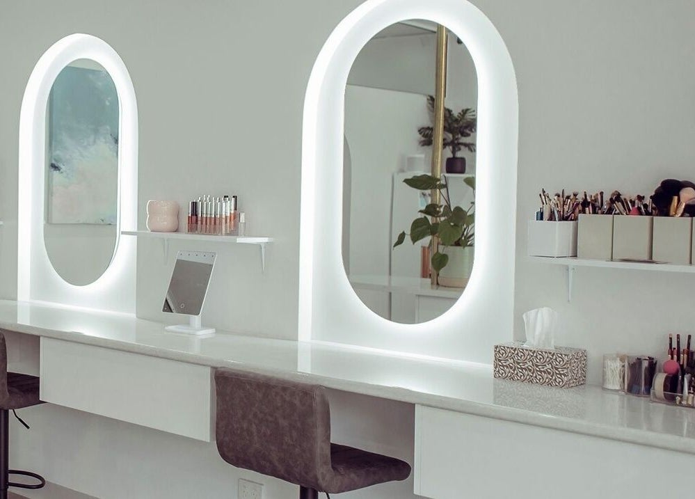 Elegant makeup station at AJ Makeup Studio, Launceston, Tasmania, AU with illuminated mirrors and beauty tools.