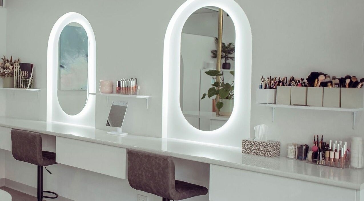 Elegant makeup station at AJ Makeup Studio, Launceston, Tasmania, AU with illuminated mirrors and beauty tools.
