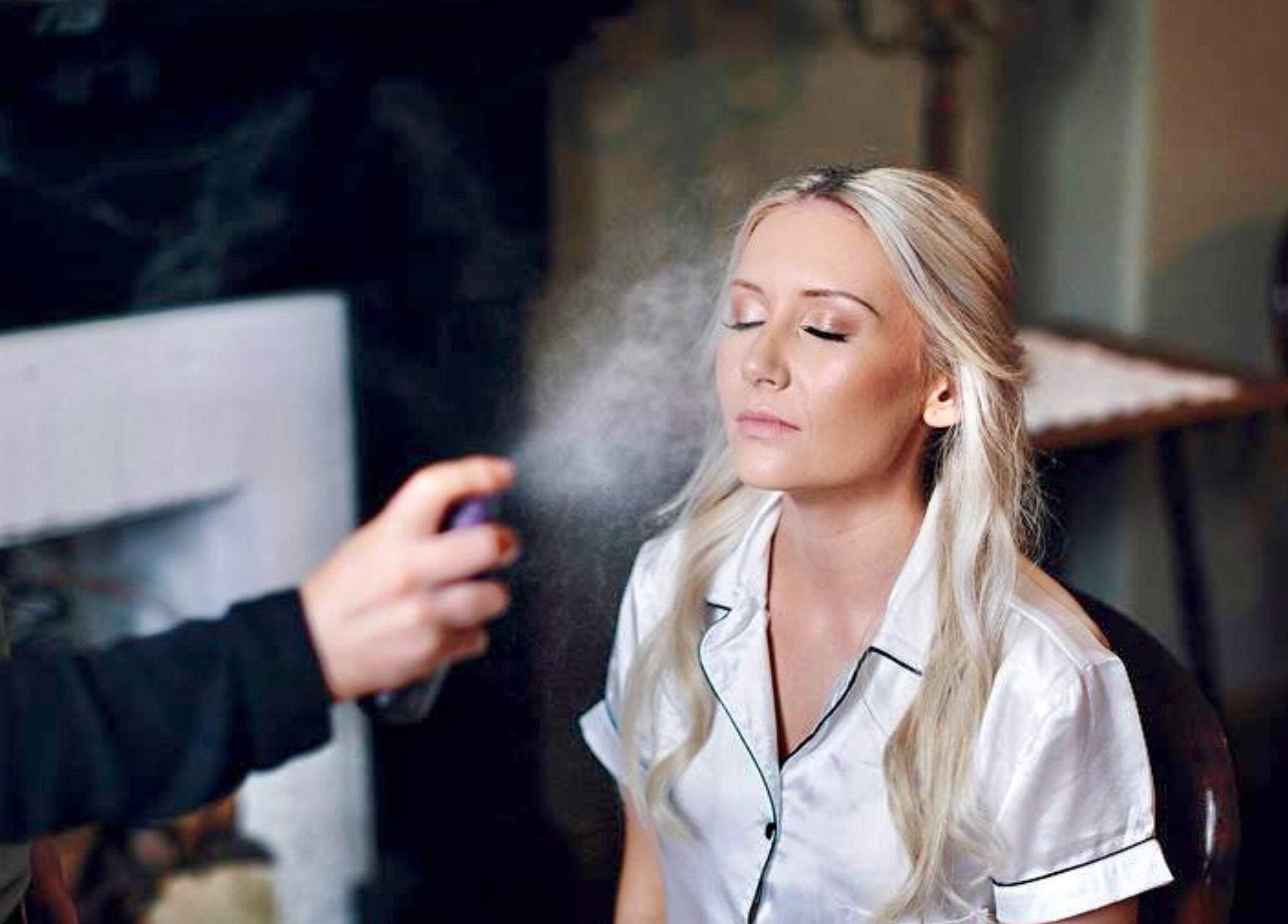 Makeup artist applies finishing spray at AJ Makeup Studio, Launceston, Tasmania, AU for a glowing look.
