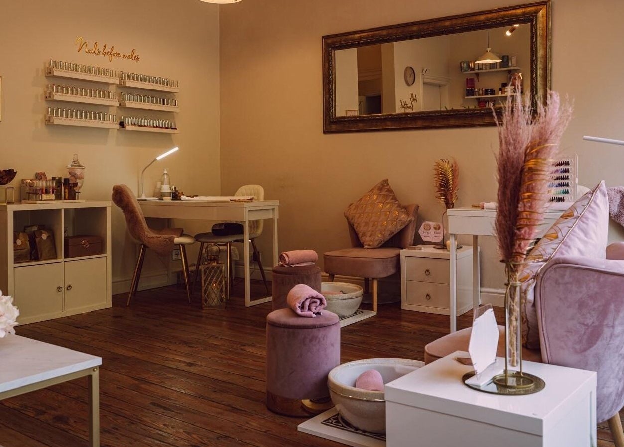 RJ Beauty's serene nail studio in Halifax, England, GB, featuring chic decor and plush seating for relaxation.